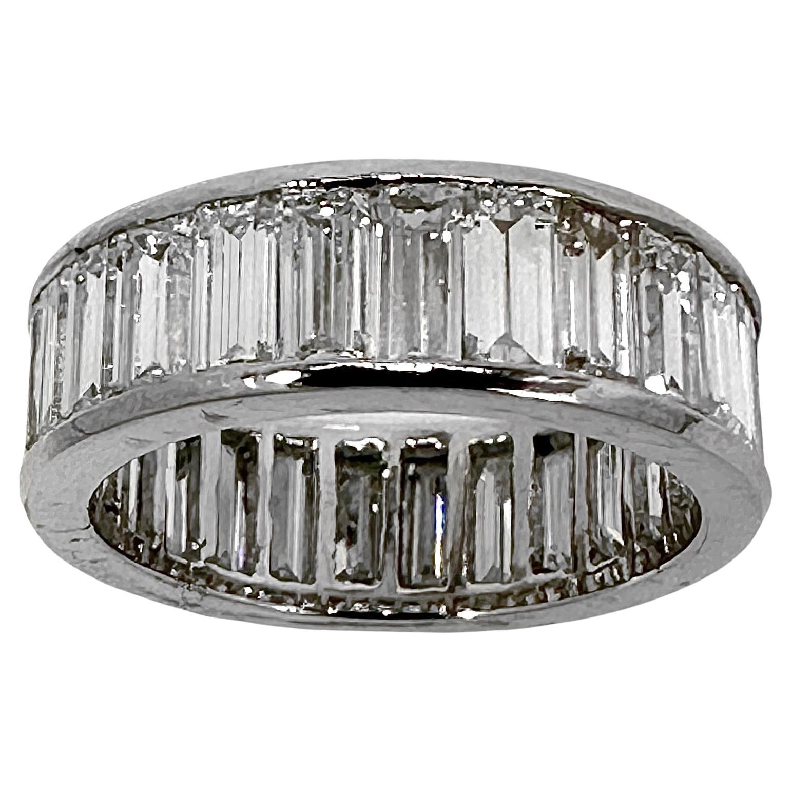 This beautifully crafted, handmade Mid-Century platinum eternity band is set all around with very large baguette cut diamonds. It is in excellent vintage condition, and is certain to deliver a lifetime of enjoyment. At a width of a full 1/4 inch,