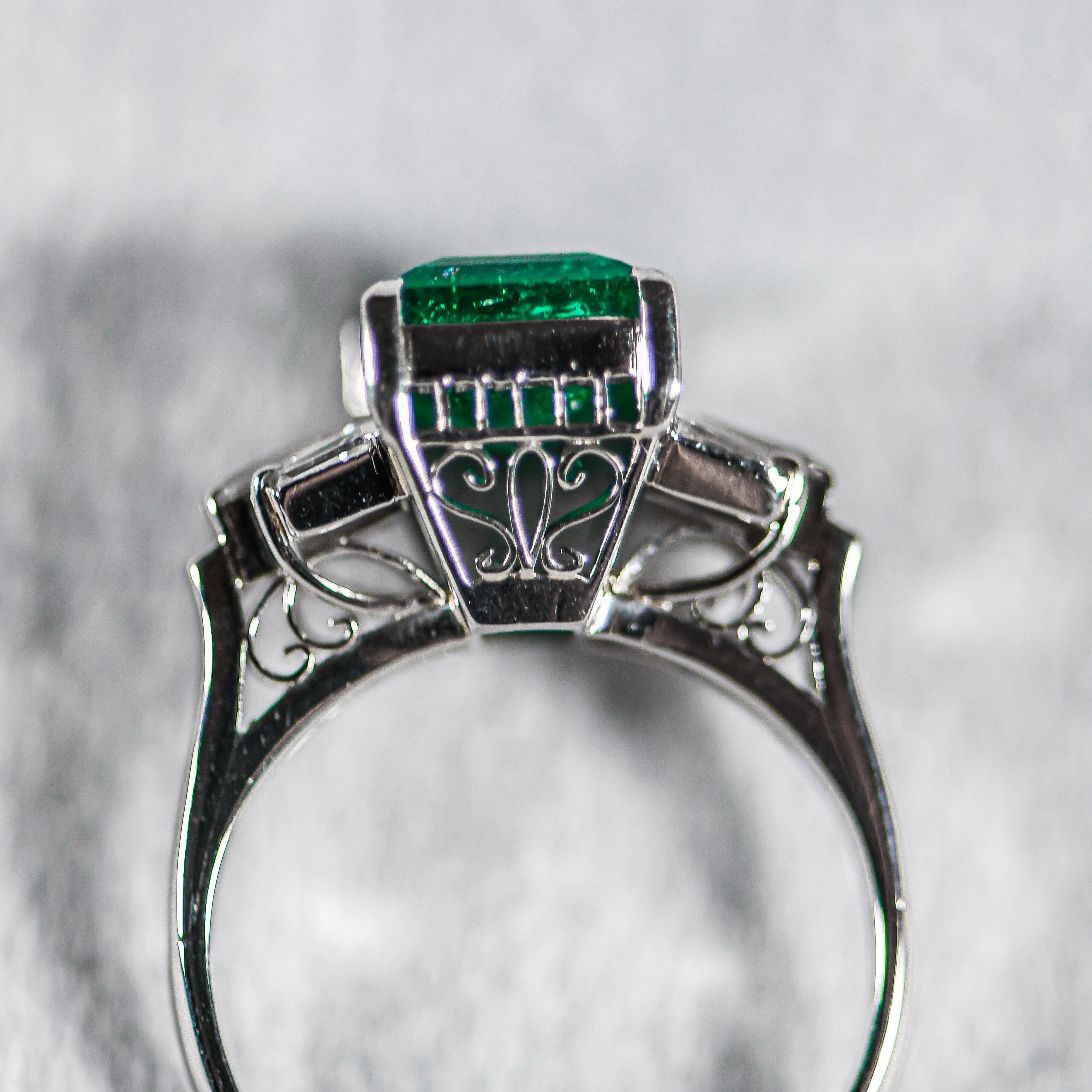  The birthstone for May and the gemstone desired in every fine jewelry collection!  This stunning emerald cut emerald is the focal point in a classic platinum setting!  2.35 carats is an impressive look! Side diamonds have an additional total weight