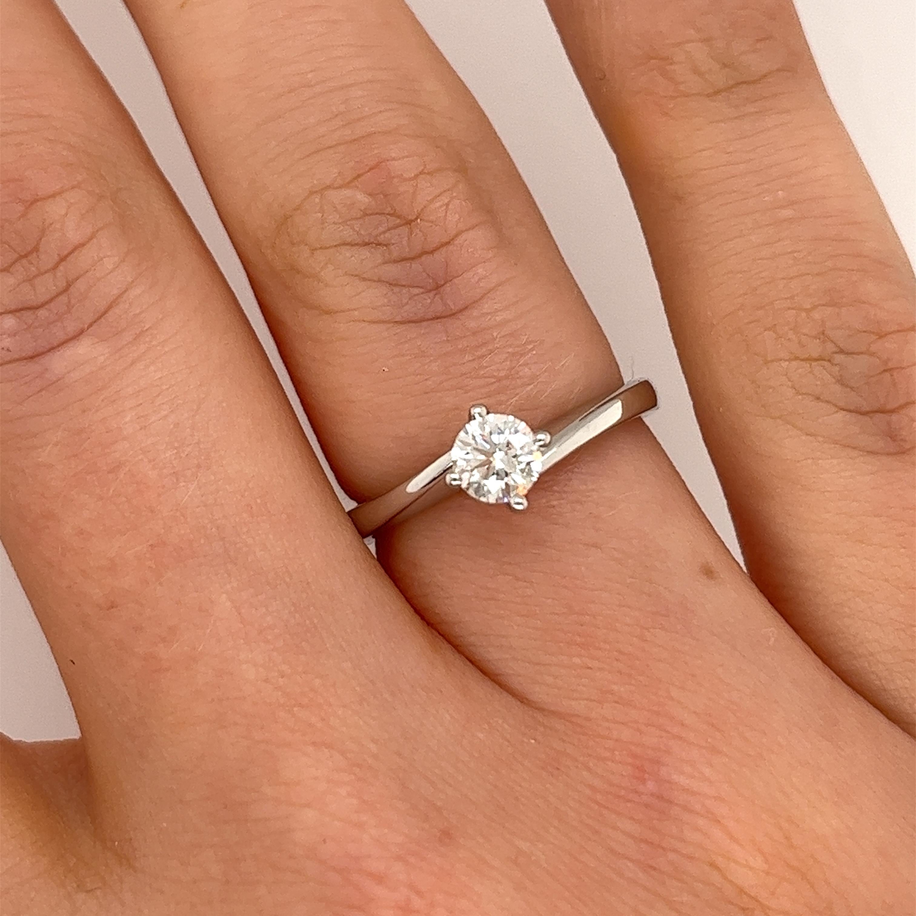 This preloved classic platinum solitaire crossover 
round brilliant cut diamond ring is set with 0.41ct F colour VS1 clarity.
A timeless symbol of everlasting love.
Total Diamond Weight: 0.41ct
Diamond Colour: F
Diamond Clarity: VS1
Width of Band: