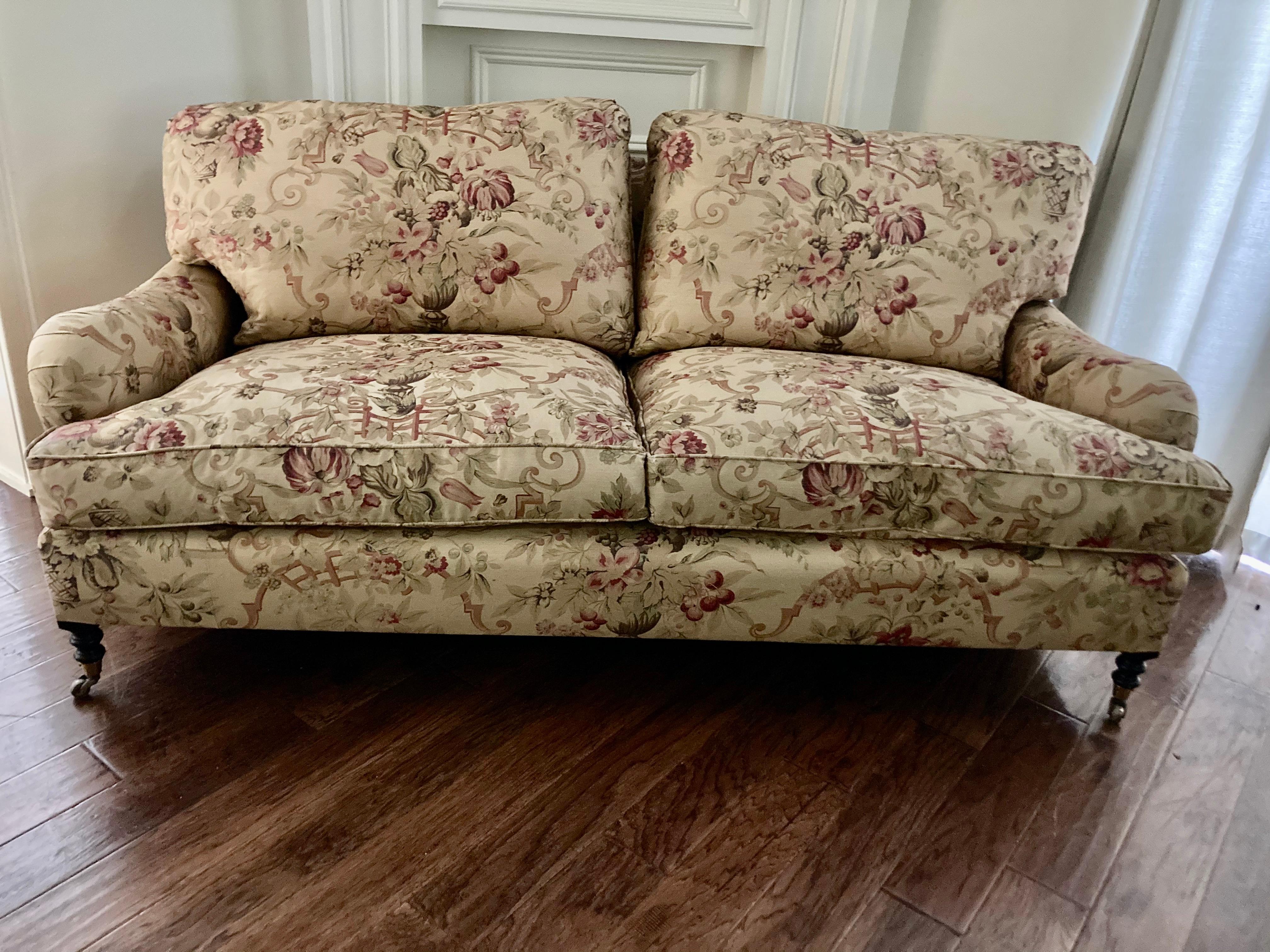 Gorgeous George smith sofa with 2 loose seat and back cushions plushly filled with plump down feathers and having elegant English roll arms. Upholstered in the sought after classic neutral George Smith Gollut fabric. 
Measure: Seat height 20.