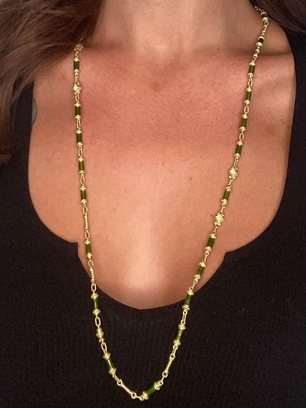 Neo classic necklace sautoir with green guilloche enamel.

Beautiful long sautoir necklace crafted with classical baroque patterns in solid rich yellow gold of 18 karats and embellished with applications of vibrant olive green enamel over a