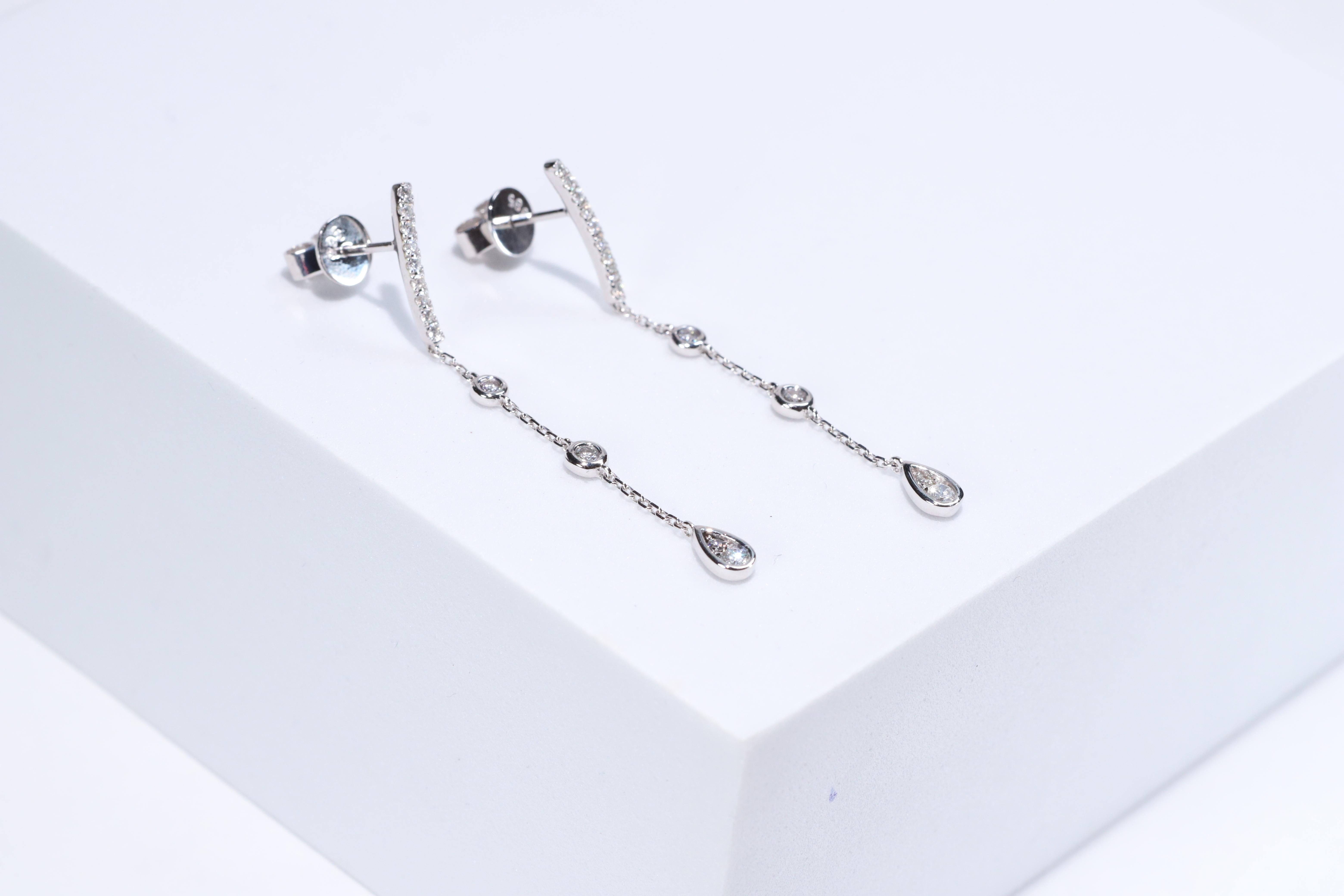 Each of these pretty earrings from Gin & Grace features a with white diamonds. These earrings are made of rich 14-karat White gold with a high polish. Style: Dangle, Diamonds: 26 pcs Diamond cut: Round Diamond weight: 0.30 carat Color: G-H Clarity: