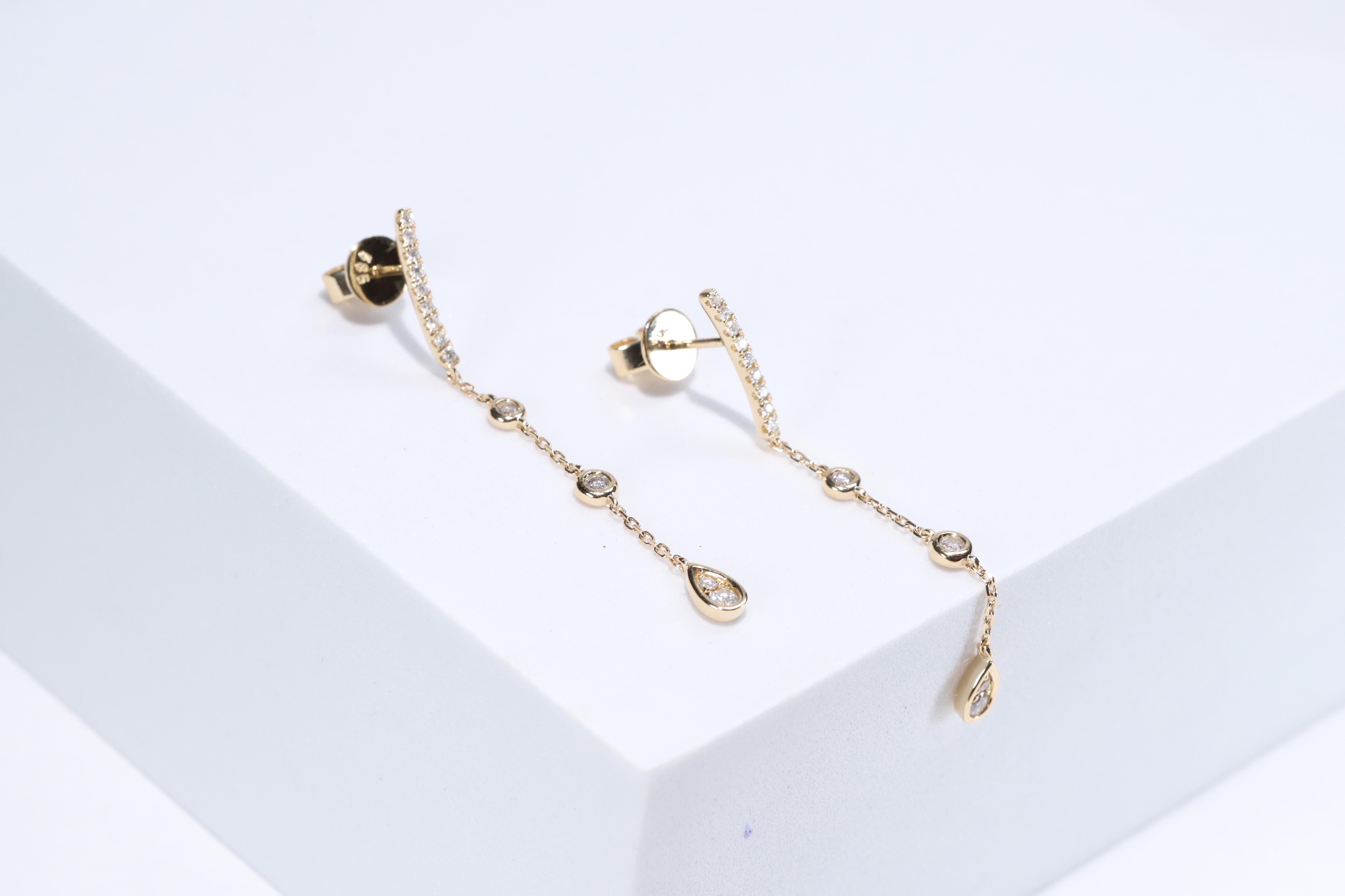 Each of these pretty earrings from Gin & Grace features a with white diamonds. These earrings are made of rich 14-karat Yellow gold with a high polish. Style: Dangle, Diamonds: 26 pcs Diamond cut: Round Diamond weight: 0.29 carat Color: G-H Clarity: