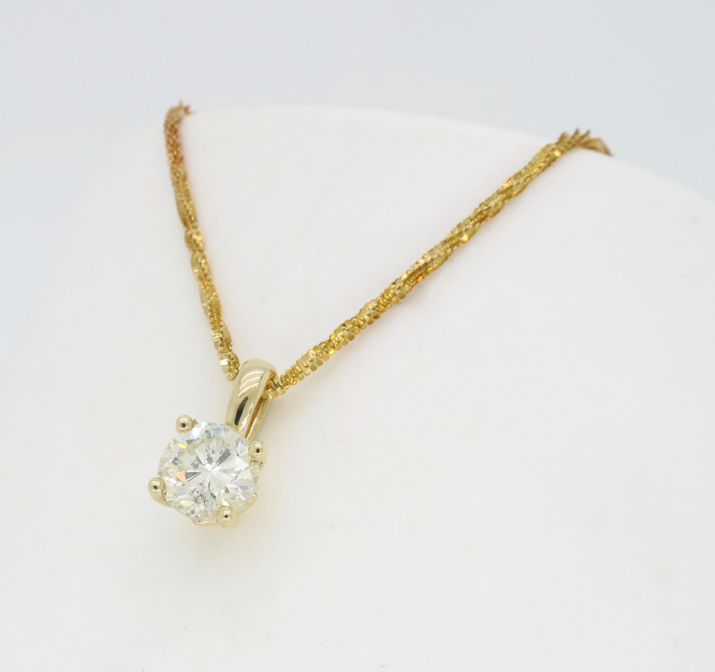 
Classic .75CT solitaire diamond pendant necklace crafted in 14k yellow gold.

Diamond Carat Weight:  .75CT
Diamond Cut: Round Brilliant Cut Diamond
Color: Average L
Clarity: I1
Metal: 14K Yellow Gold
Chain Length: 18” Long
Marked/Tested: Stamped 