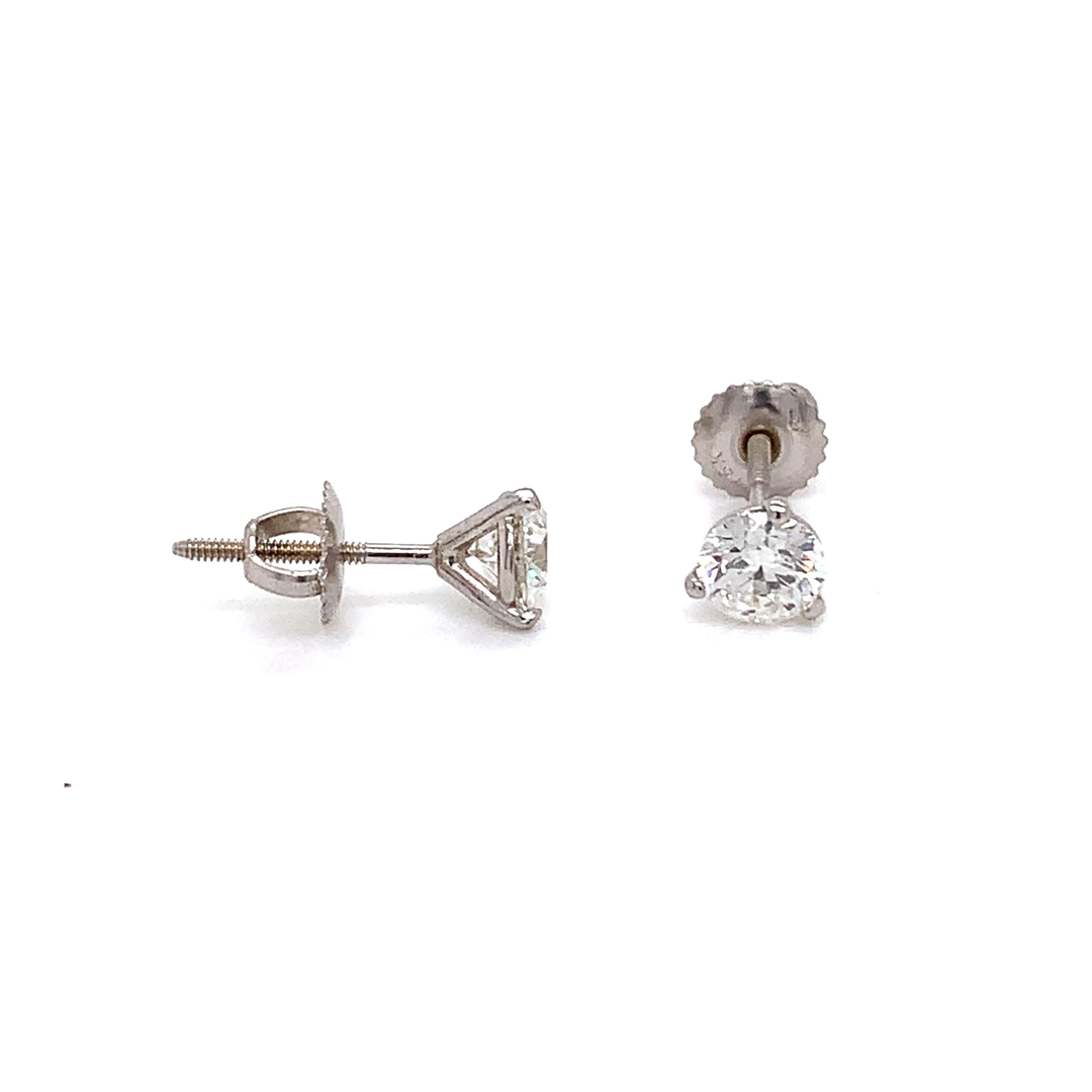 Diamond stud earrings made with real/natural brilliant cut diamonds. Total Diamond Weight: 1.19 carats. Diamond Quantity: 2 round diamonds. Color: H-I Clarity: SI1-SI2 Mounted on 18 karat white gold screw back setting.