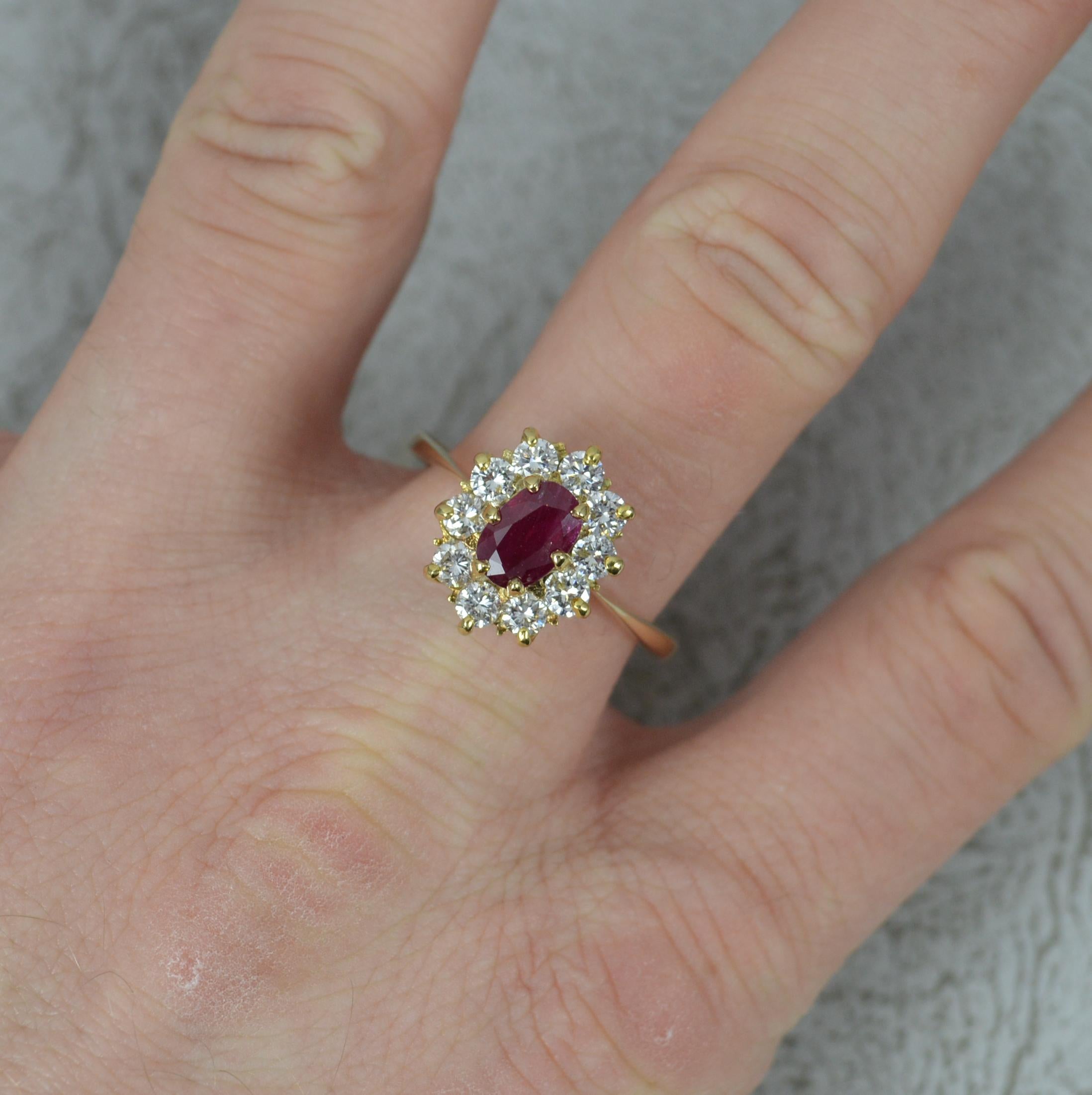 A classically designed cluster ring.
Solid 18 carat yellow gold example.
Set with an oval cut ruby in four claw setting. 4.6mm x 7.2mm. 
Surrounding are ten natural round brilliant cut diamonds to total approx 0.8-0.9 carat.
11.2mm x 13.7mm cluster