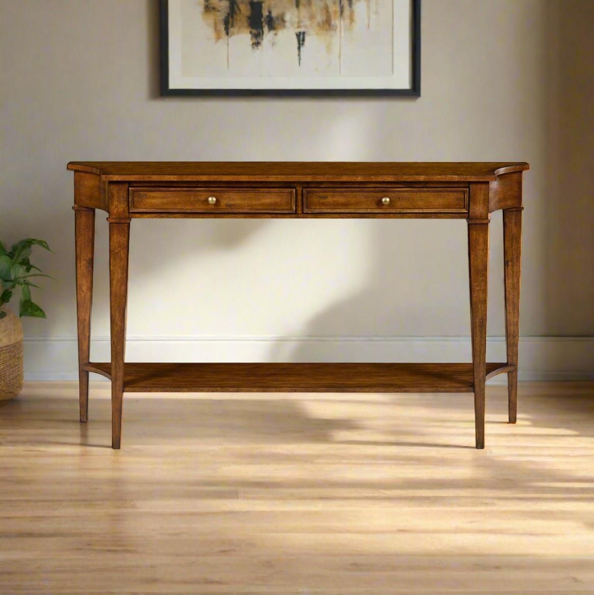 A Classic Rustic warm stained console table with a shaped top with incurved ends, on square tapered legs with a long frieze drawer and shelf stretcher base.

Dimensions: 60