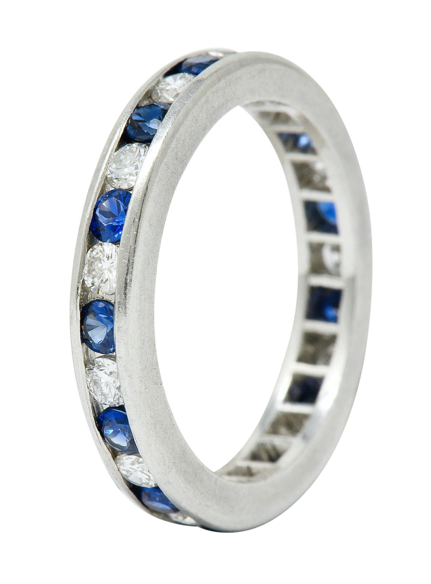 Eternity band ring channel set fully around by diamonds and sapphires, alternating

Round brilliant cut diamonds weigh in total approximately 0.40 carat; G/H color with SI clarity

Well-matched and bright royal blue sapphires weigh in total