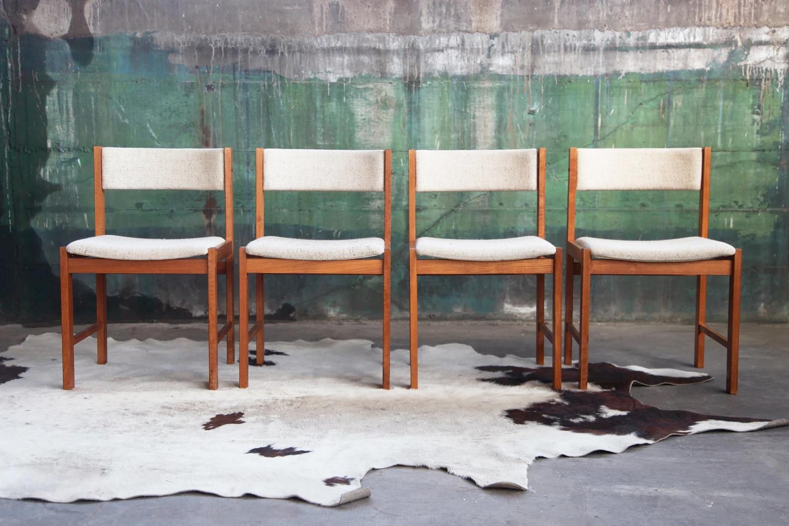 Here is a rare opportunity to purchase a beautiful, classic, sturdy and beautifully made set of four solid wood teak Danish chairs. They are highly collectible, iconic, and very stylish Mid Century Teak dining chairs by DScan, upholstered with