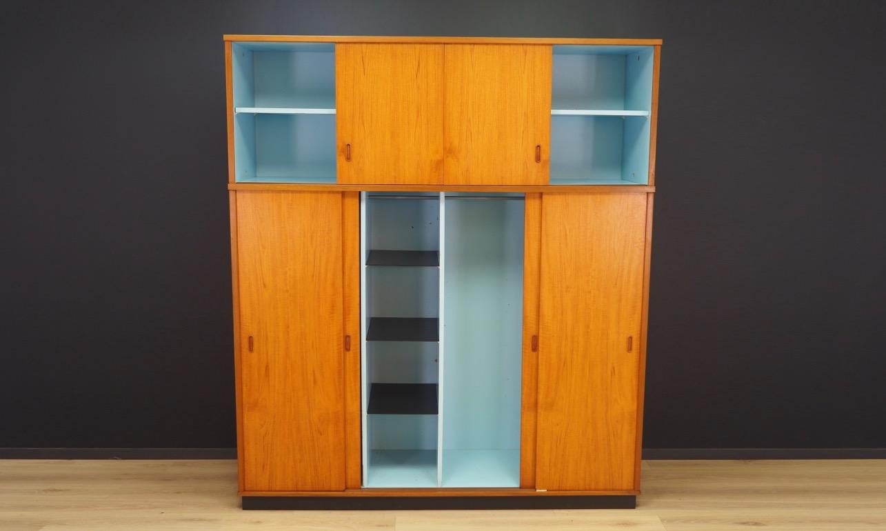 Classic wardrobe from the 1960s-1970s, Minimalist form - Scandinavian design. Finished with teak veneer. Behind the sliding doors the wardrobe has shelves and a roomy space with a hanger. Preserved in good condition (visible small bruises and