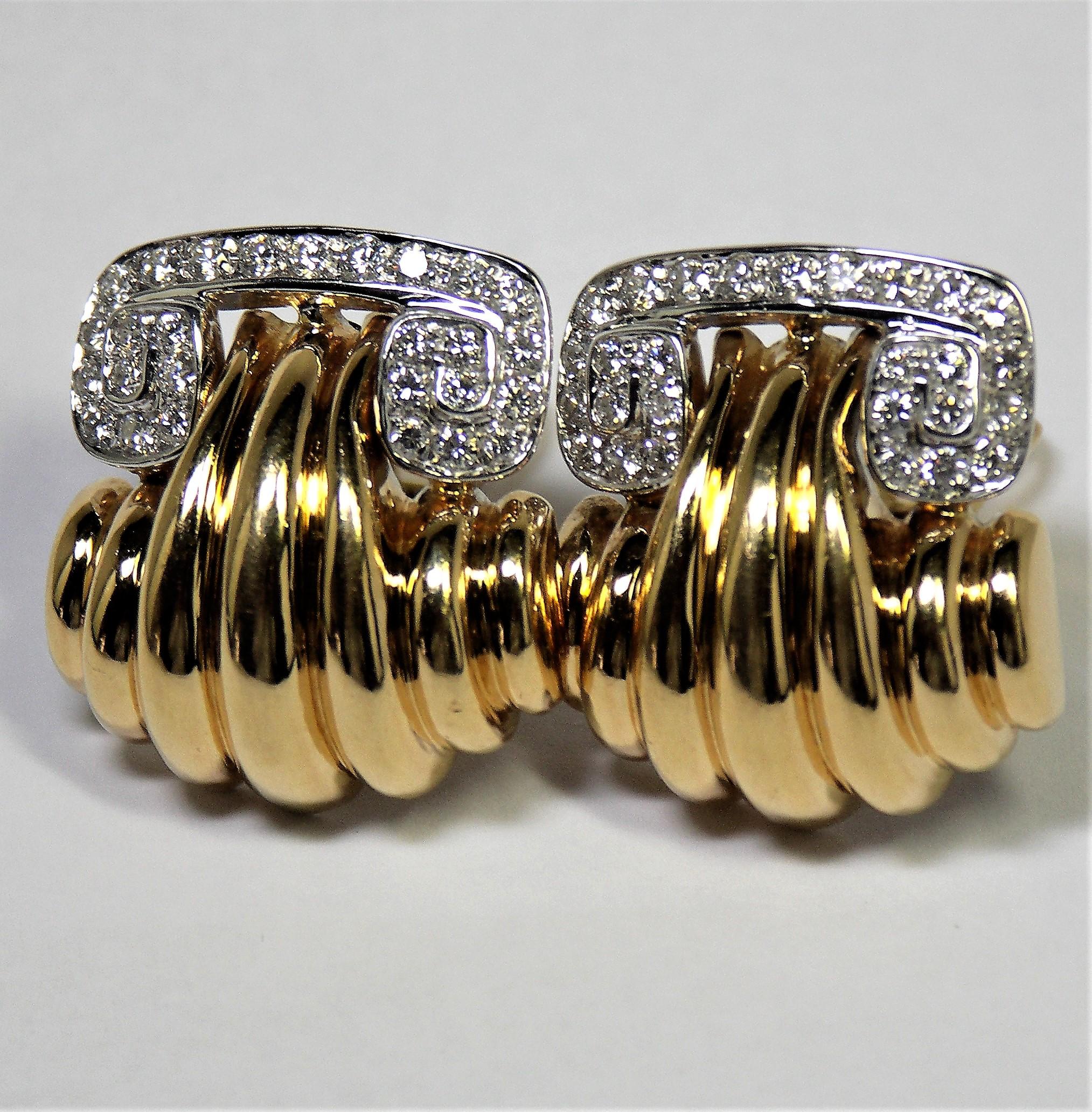 Made of 18K Yellow Gold, these classic, scroll top design clip on earrings
are set with 54 round brilliant cut diamonds weighing an approximate total weight of 2.30 carats of overall G Color and VS1 Clarity. Measuring 
1  3/16 inch from top to