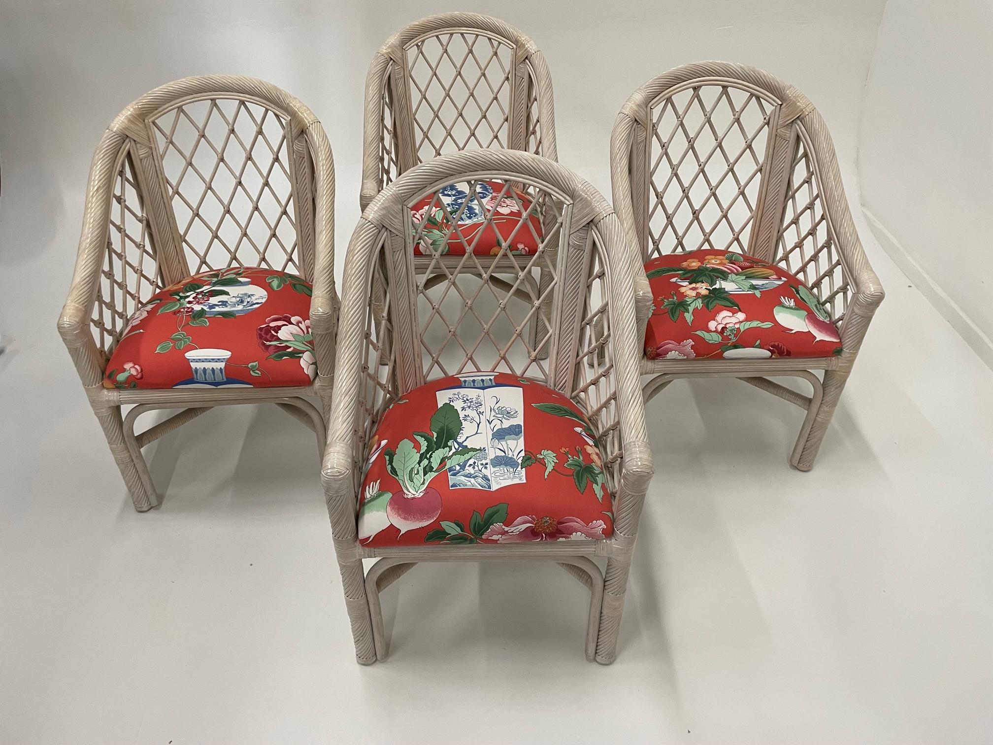 Classic set of 4 McGuire barrel back whitewashed rattan armchairs having stylish newly upholstered seats in a striking cotton decorated with Chinese blue and white vases against red background.
Measure: Arm height 25.