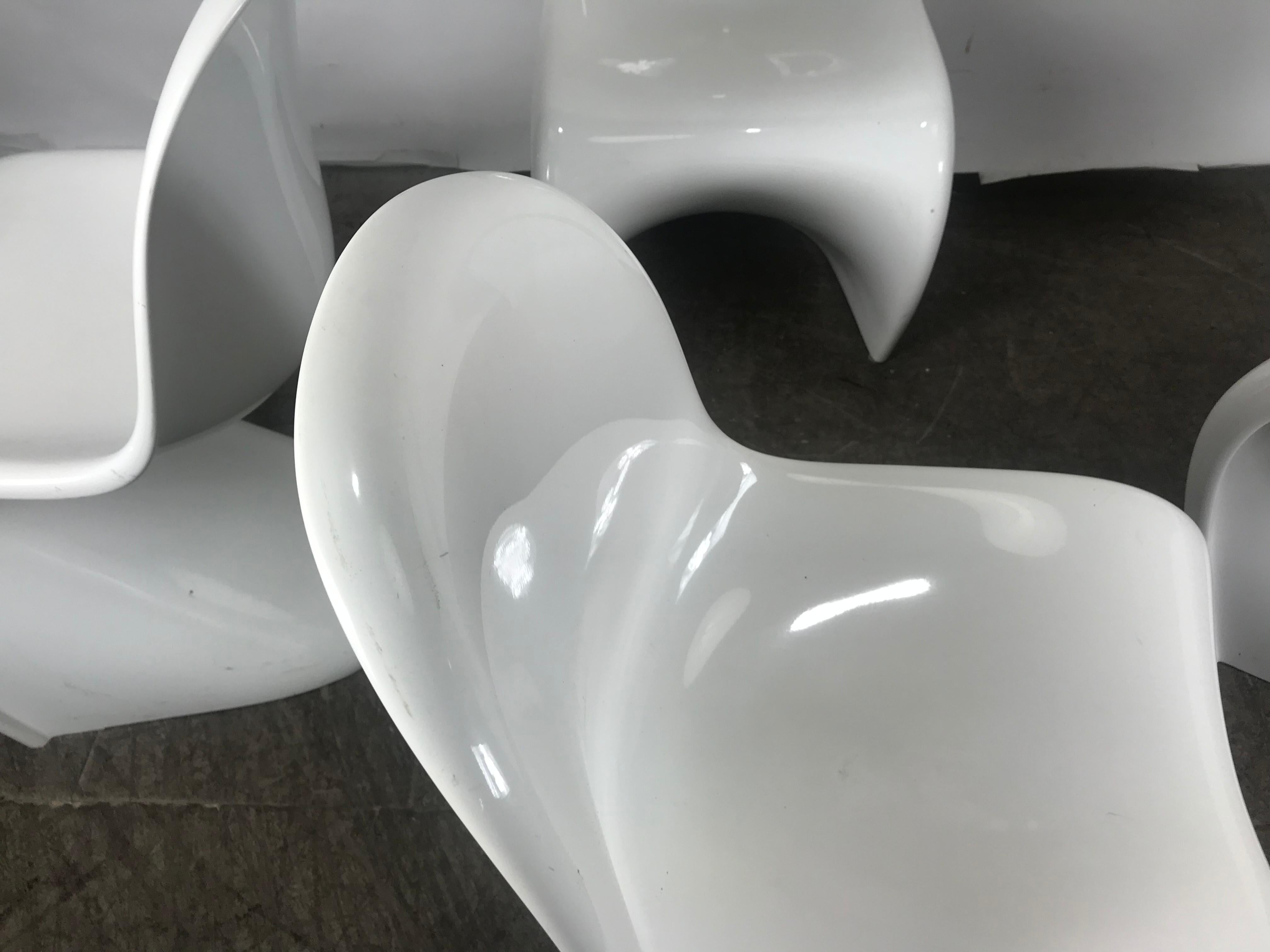 A iconic pure white stacking chair by influential Danish architect and designer Verner Panton (1926-1998). Designed in 1958, this cantilevered, stackable chair is the first single-form, injection-molded plastic chair ever produced. A masterpiece of