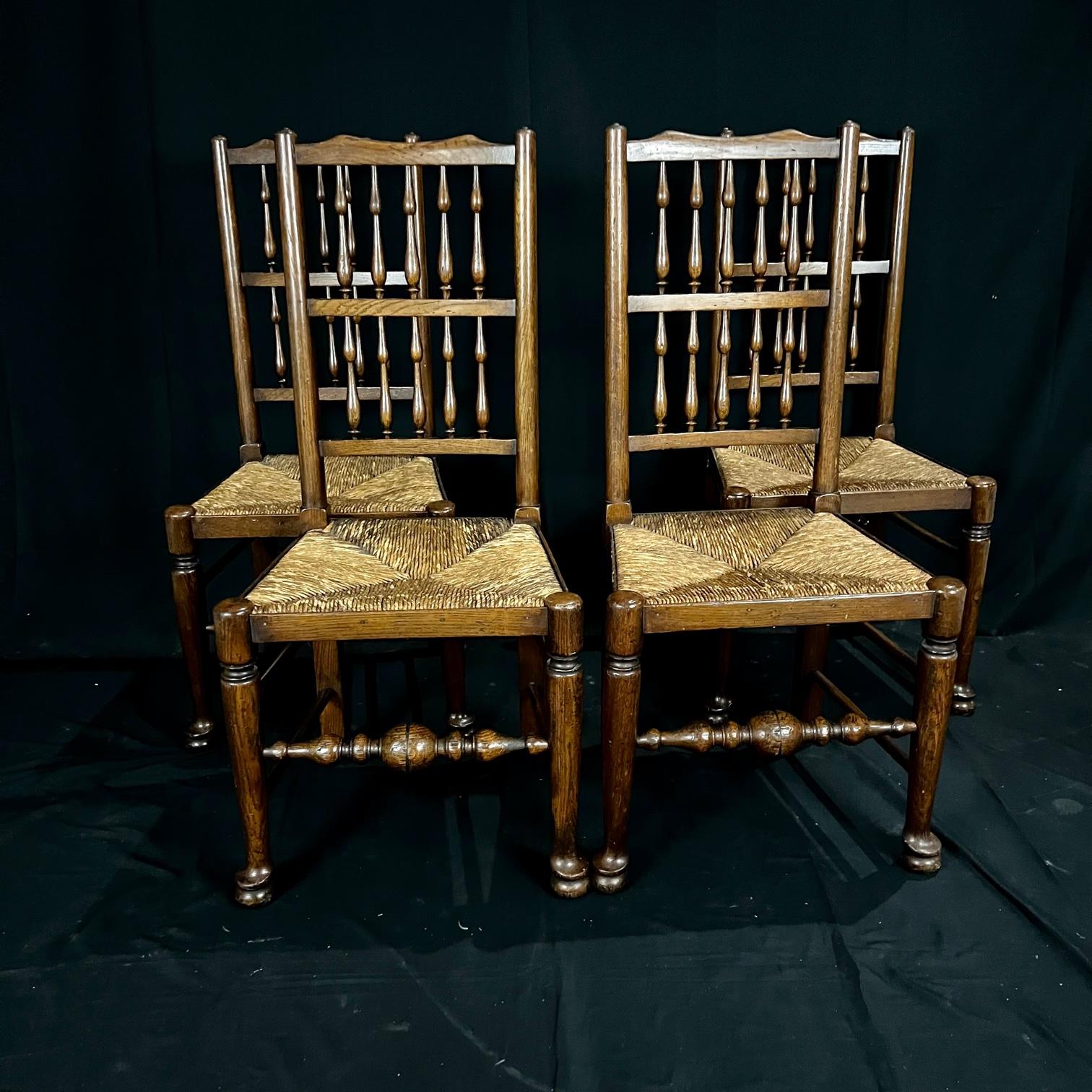 Really lovely set of four early 19th century carved oak British dining chairs with original patina and rush seats. #4178.