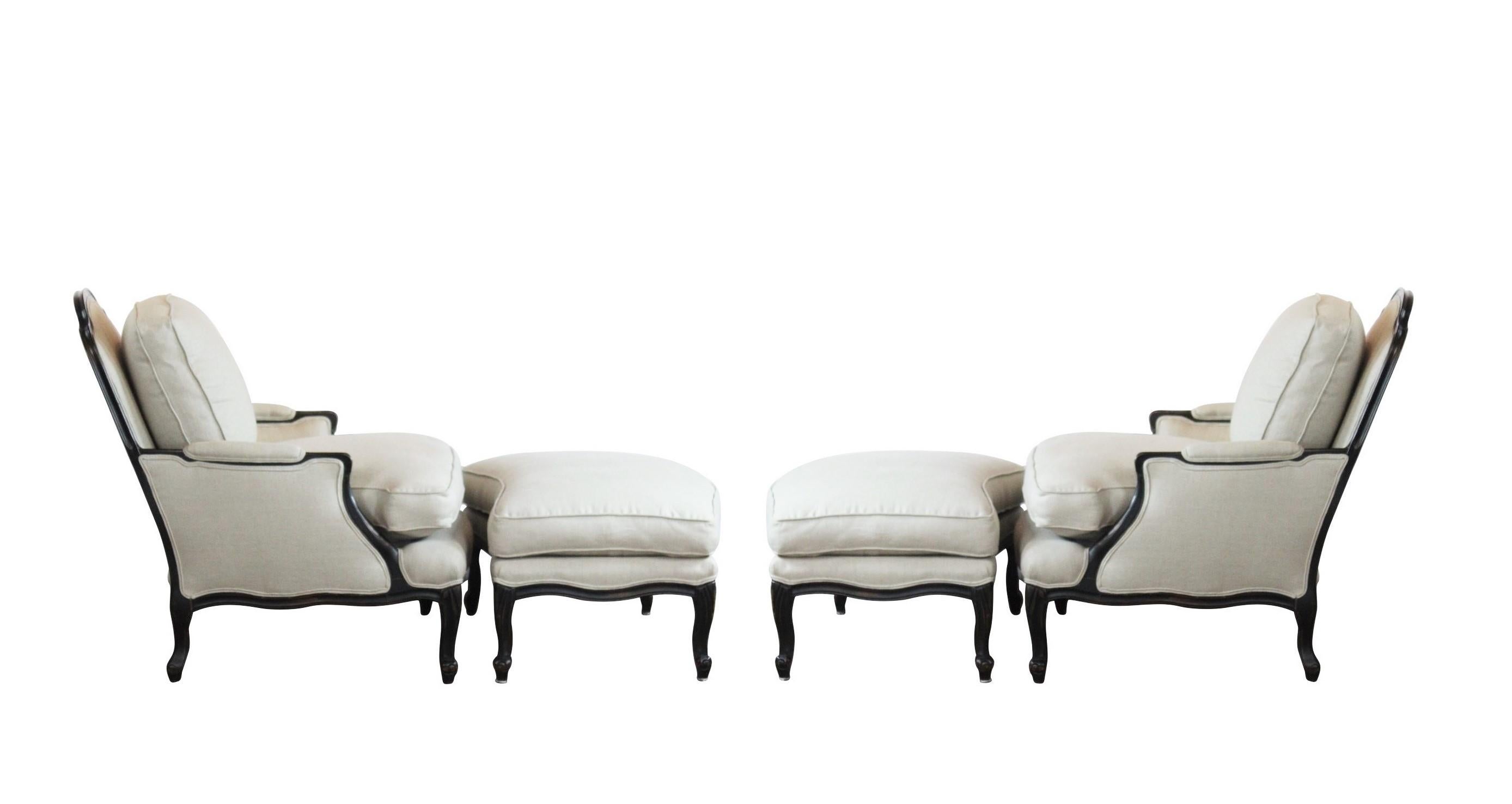 Pair of over-sized Louis XV style bergères and matching curved ottomans. The chairs features newly refinished frames in dark stain in a squared back with an arched crest rail and rounded ears. It has straight, fluted arms and a cushioned seat with a