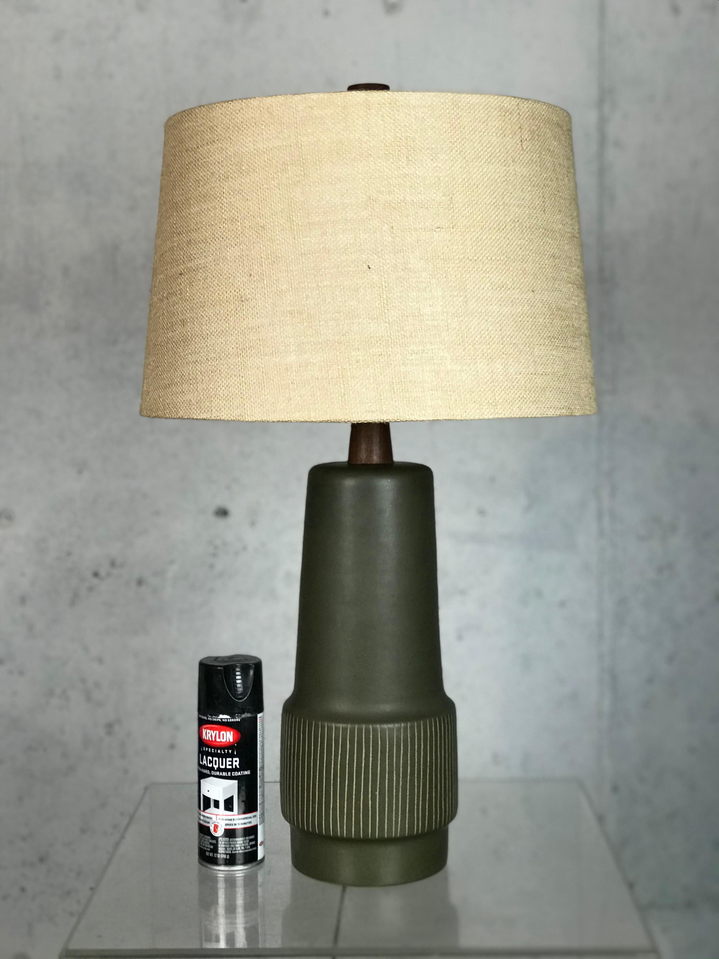 Wonderful classic Martz sgraffito ceramic lamp in tan and olive green matte glaze with a teak neck and finial. The darkness of the teak, and the style of the original wiring and harp show that this is an early model - yet looks excellent with no