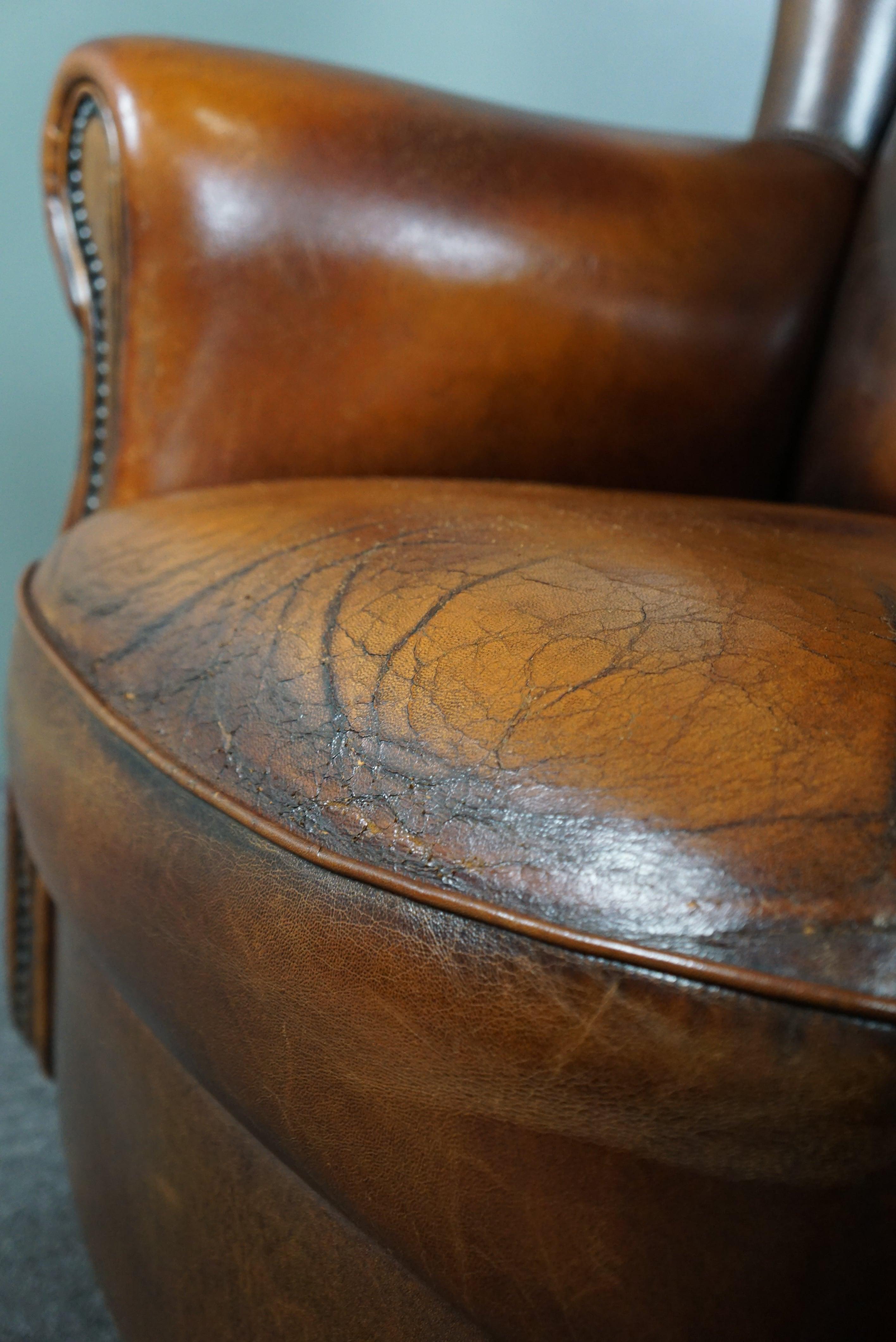 Classic sheepskin wingback chair with a beautiful patina For Sale 5