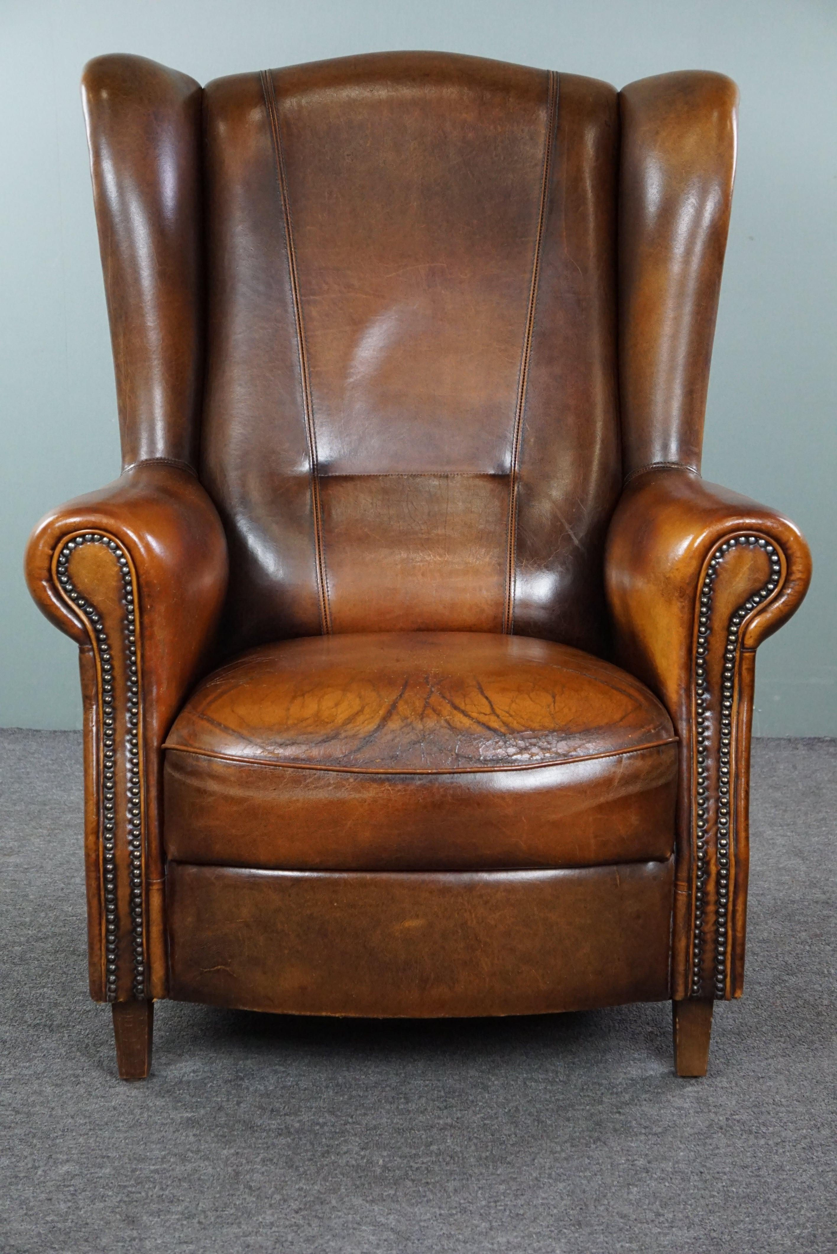 Offered is this lovely sheepskin wingback chair with character and proper seating. Discover the unique charm of this characteristic wingback chair crafted in high-quality sheepskin leather. This chair not only exudes style but also tells a story