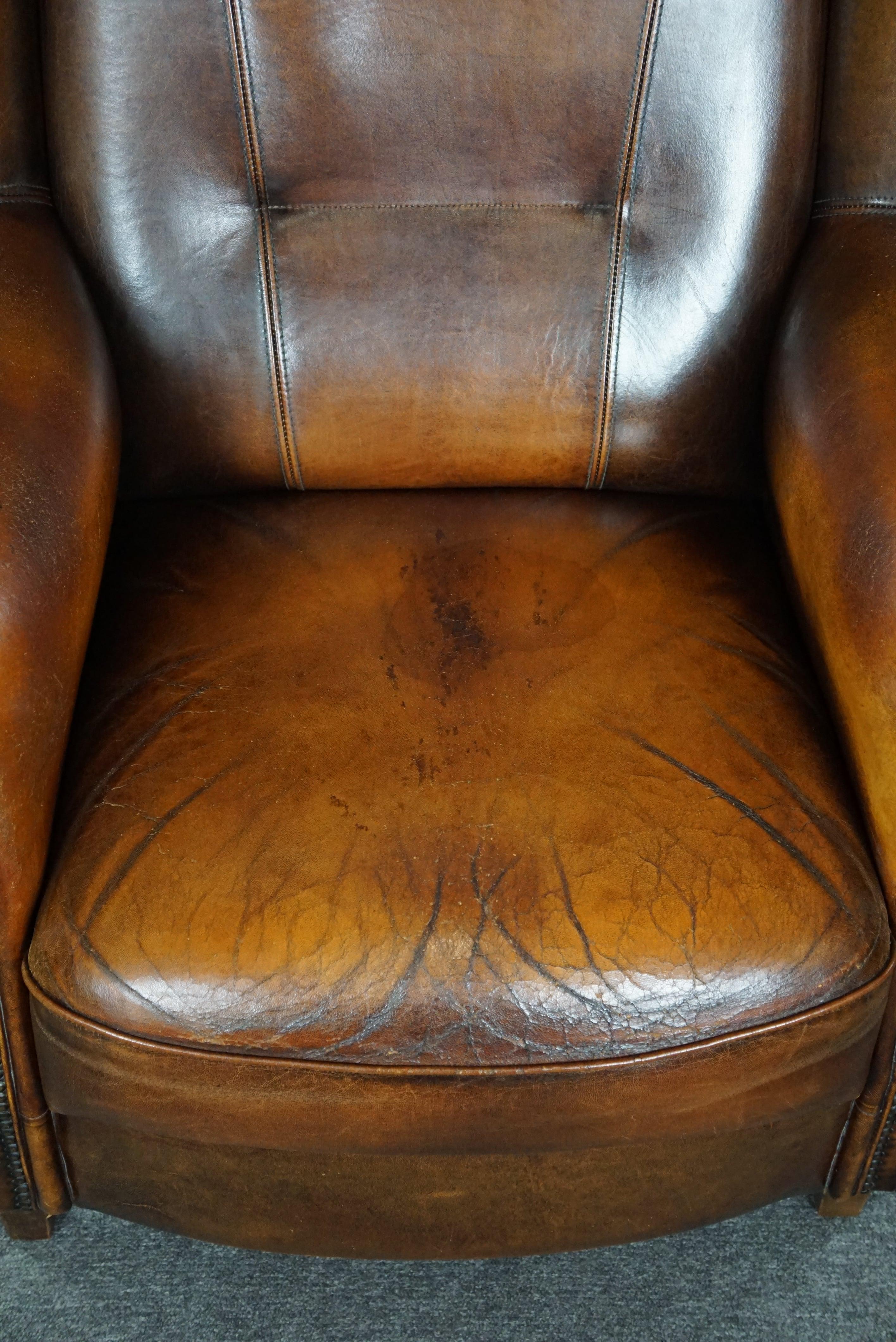 Classic sheepskin wingback chair with a beautiful patina For Sale 1