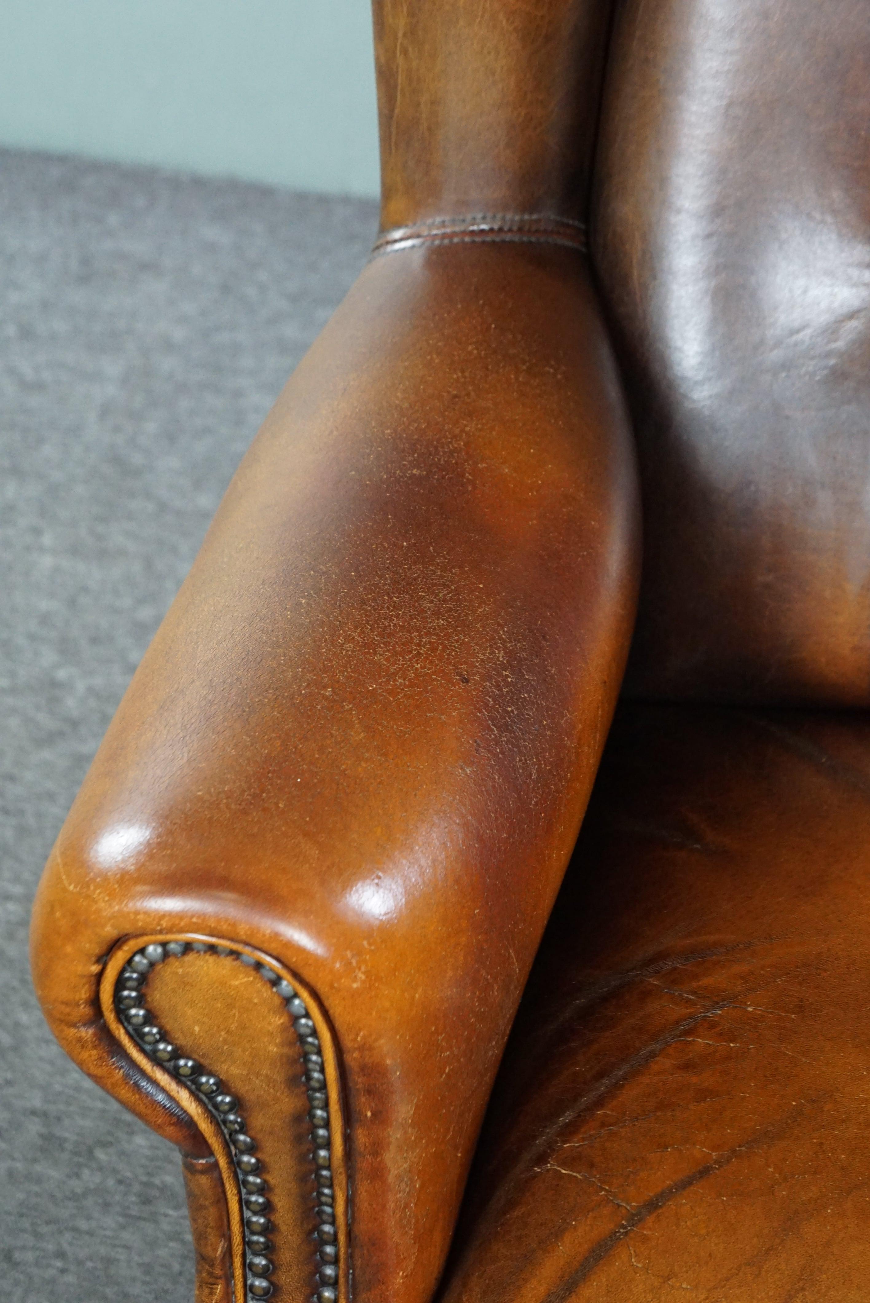 Classic sheepskin wingback chair with a beautiful patina For Sale 2