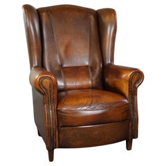 Classic sheepskin wingback chair with a beautiful patina