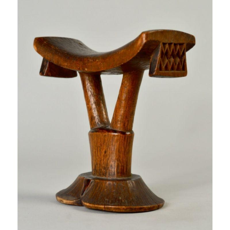 Classic Shona Headrest in Wood, Early 20th C.

This elegant, early twentieth c. headrest is from the Shona people of Zimbabwe. Most of the classic elements of Shona design are present: the figure 8 footprint, the elongated upturned saddle with
