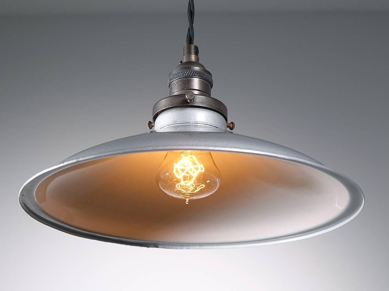 When you think industrial lighting this is the look most envision first. This classic silver over white paint finish on a pressed tin shade. The silver gray paint has an interesting two-tone hammered look. The feel is a bit less industrial with a