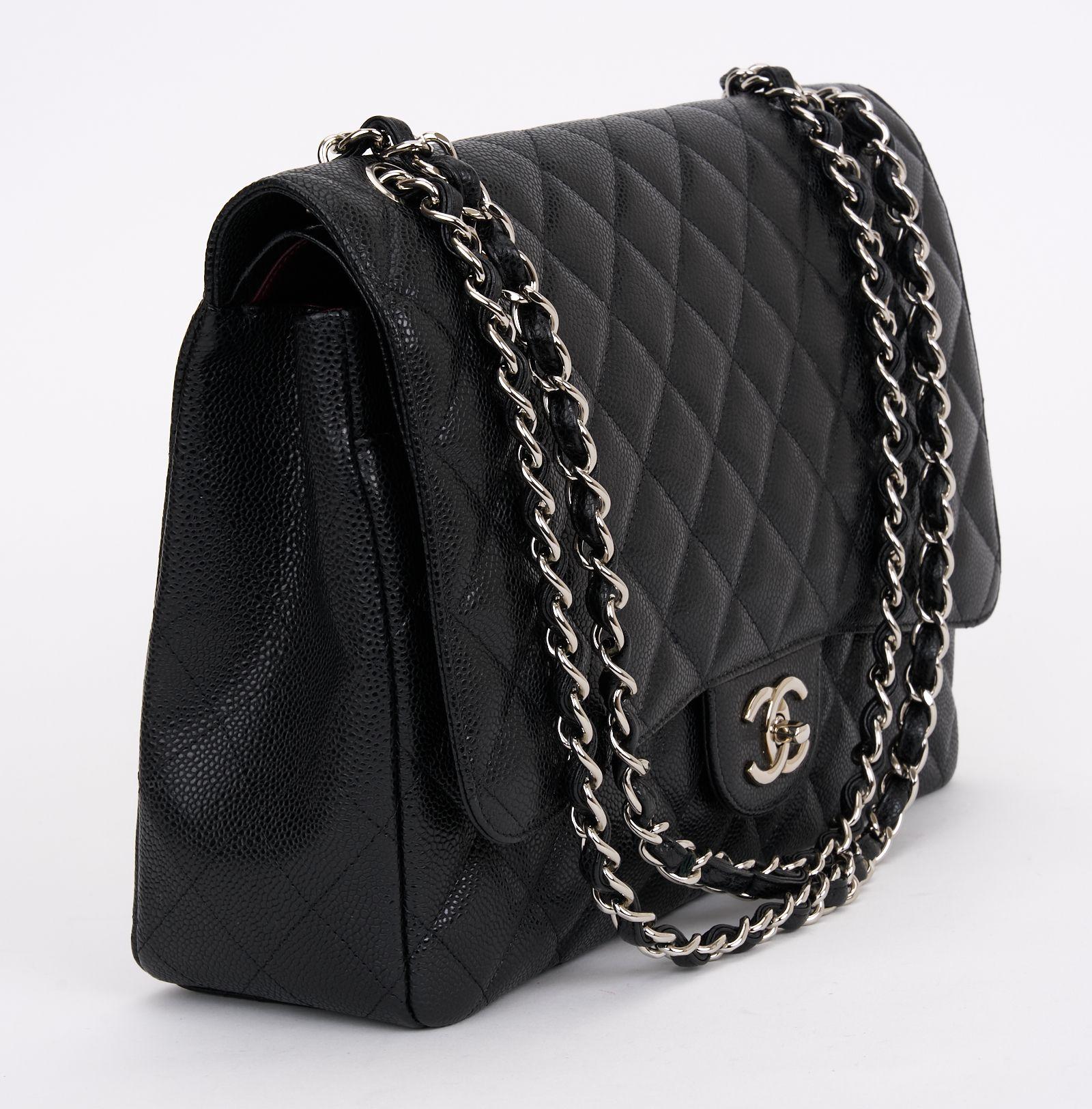 This Maxi Chanel Single Flap Bag from Caviar quilted leather features silver hardware, a CC turn-lock, and a leather entwined strap. The bag opens up to a burgundy interior. Original box, dust cover, and ID card included. The first two numbers of