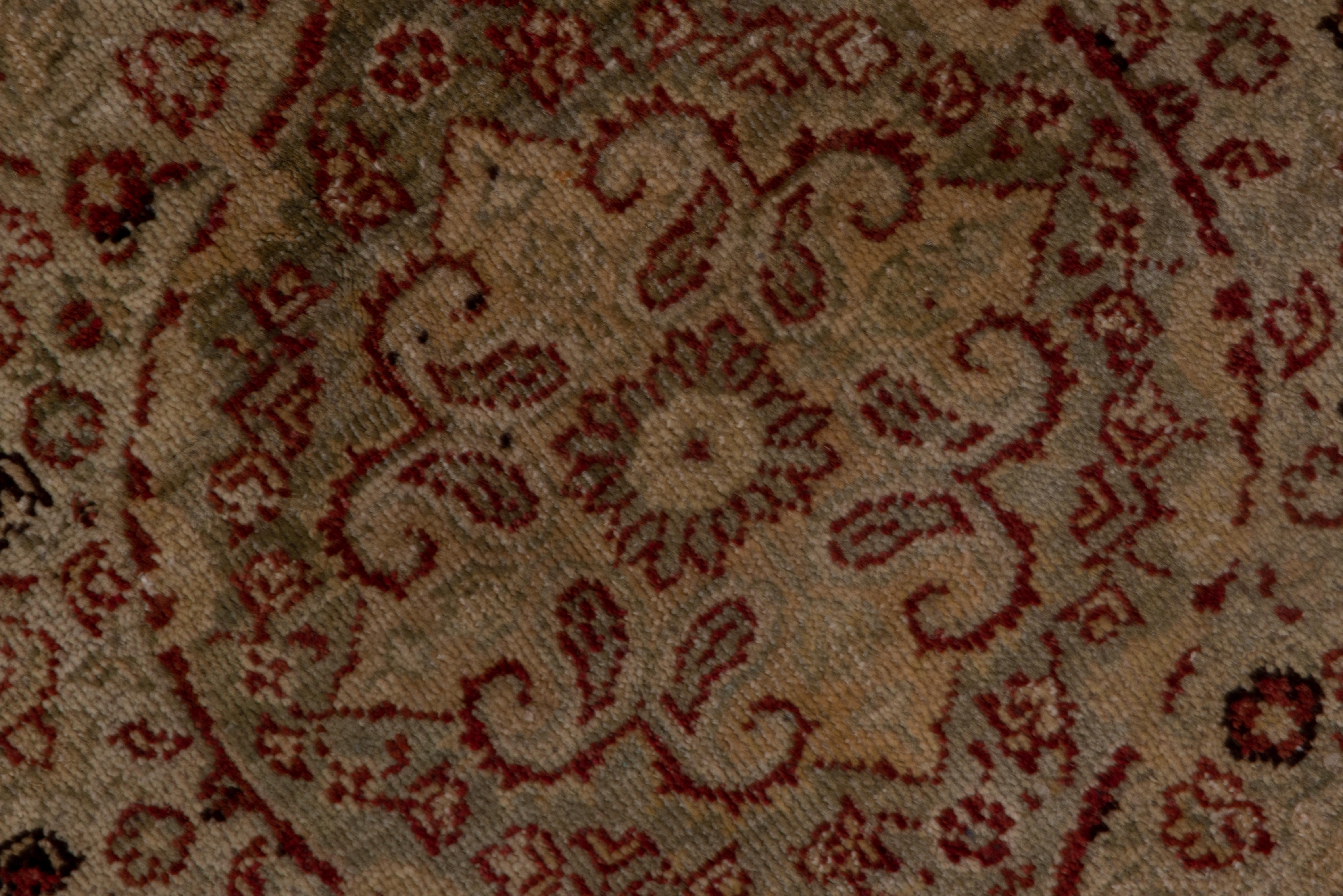 The brownish-red field on this sivas runner displays a close background fills of vines, stems, leavers and small flowers, all easily flowing around five nested elliptical pointed medallions. Botehs decorate the half and quarter side and corner