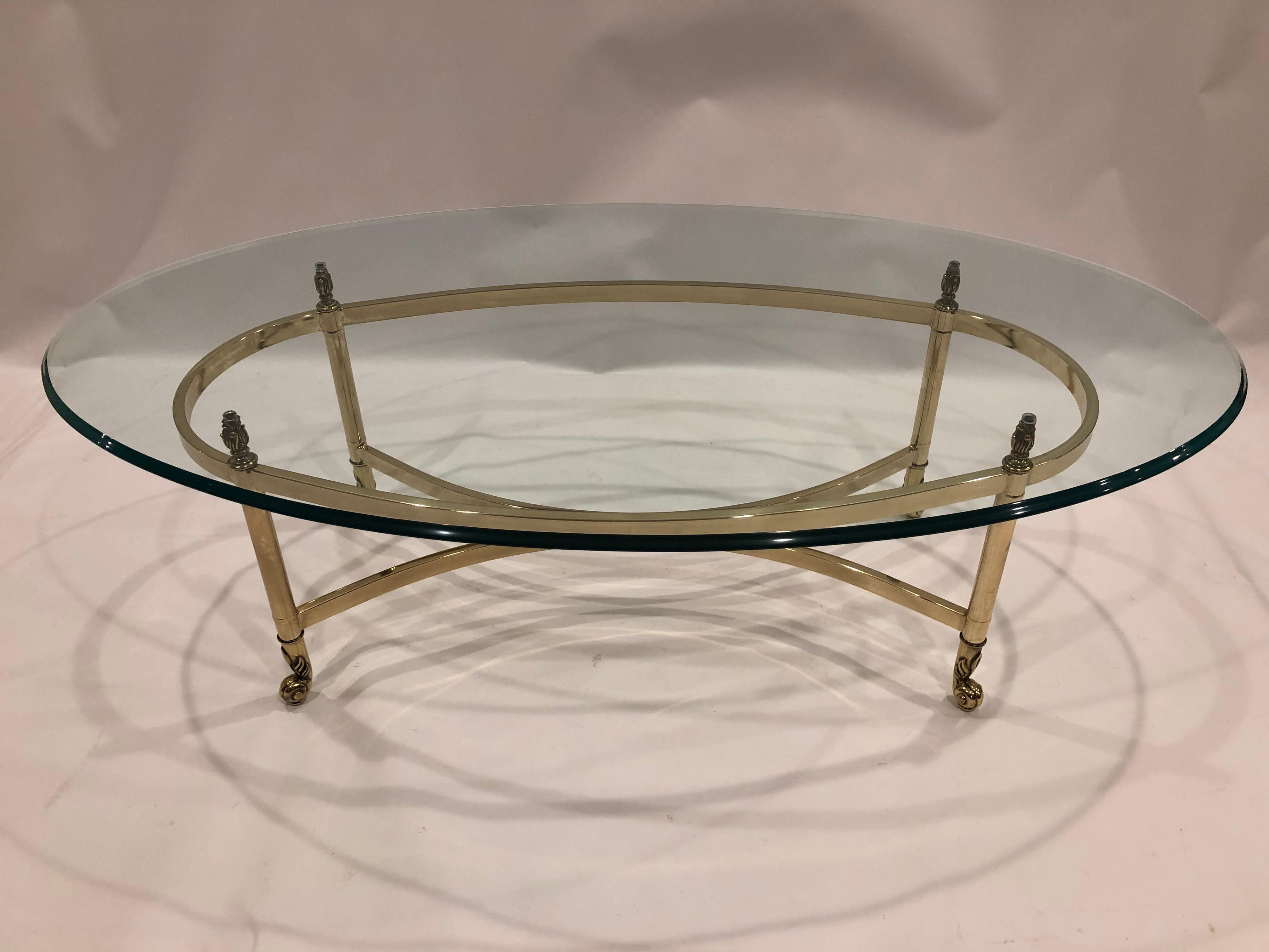 Timeless and elegant oval sleek coffee table by La Barge having lovely brass base and glass top.
Measures: Base is 40 W 19.75 D 16.25 H.