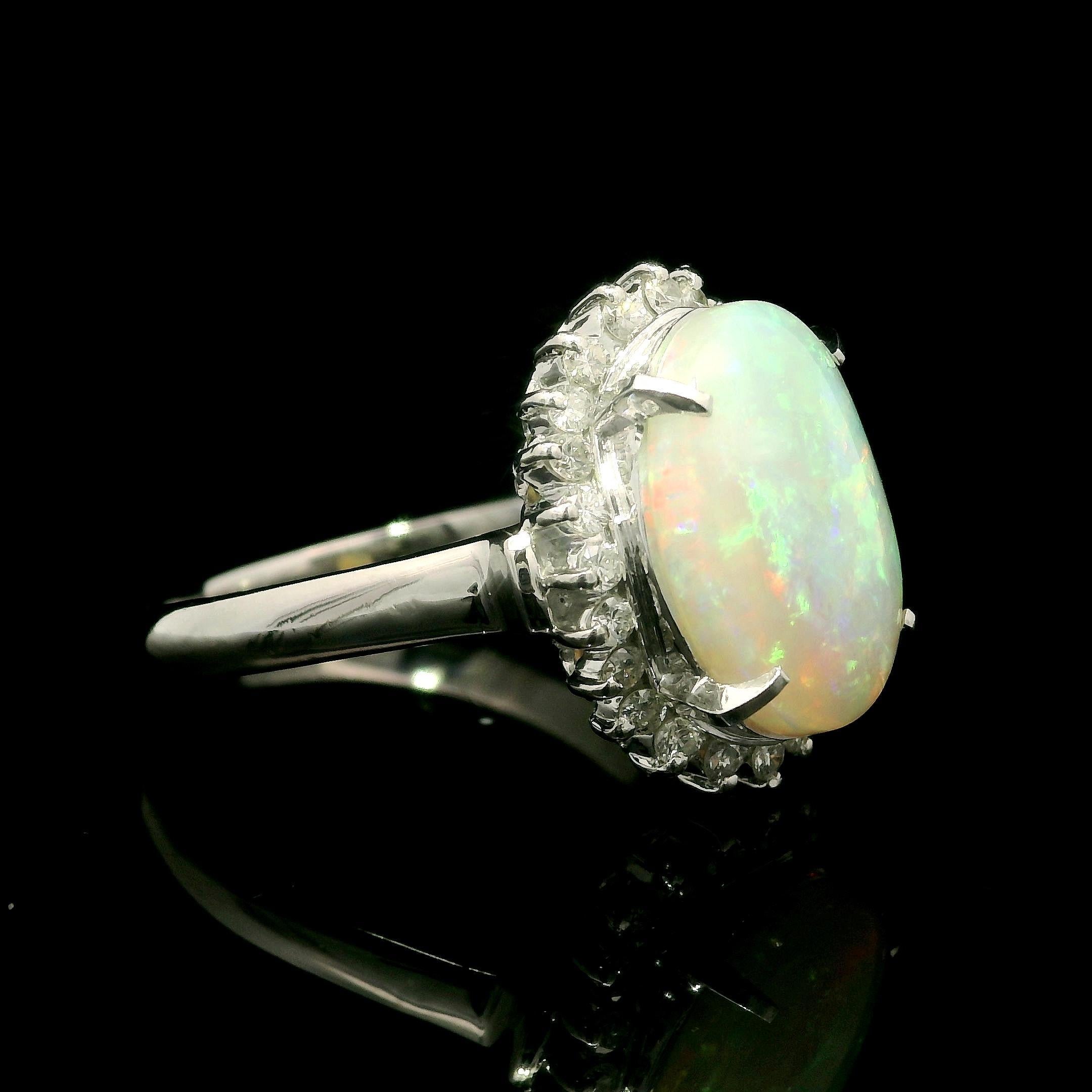 --Stone(s):--
(1) Natural Genuine Opal - Oval Cabochon Cut - Prong Set - White Color w/ Nice Play of Colors - 13.7x9.7mm /2.96ct (exact)
Numerous Natural Genuine Diamonds - Round Brilliant Cut - Prong Set - Nice Brilliant White Color - 0.35ctw
