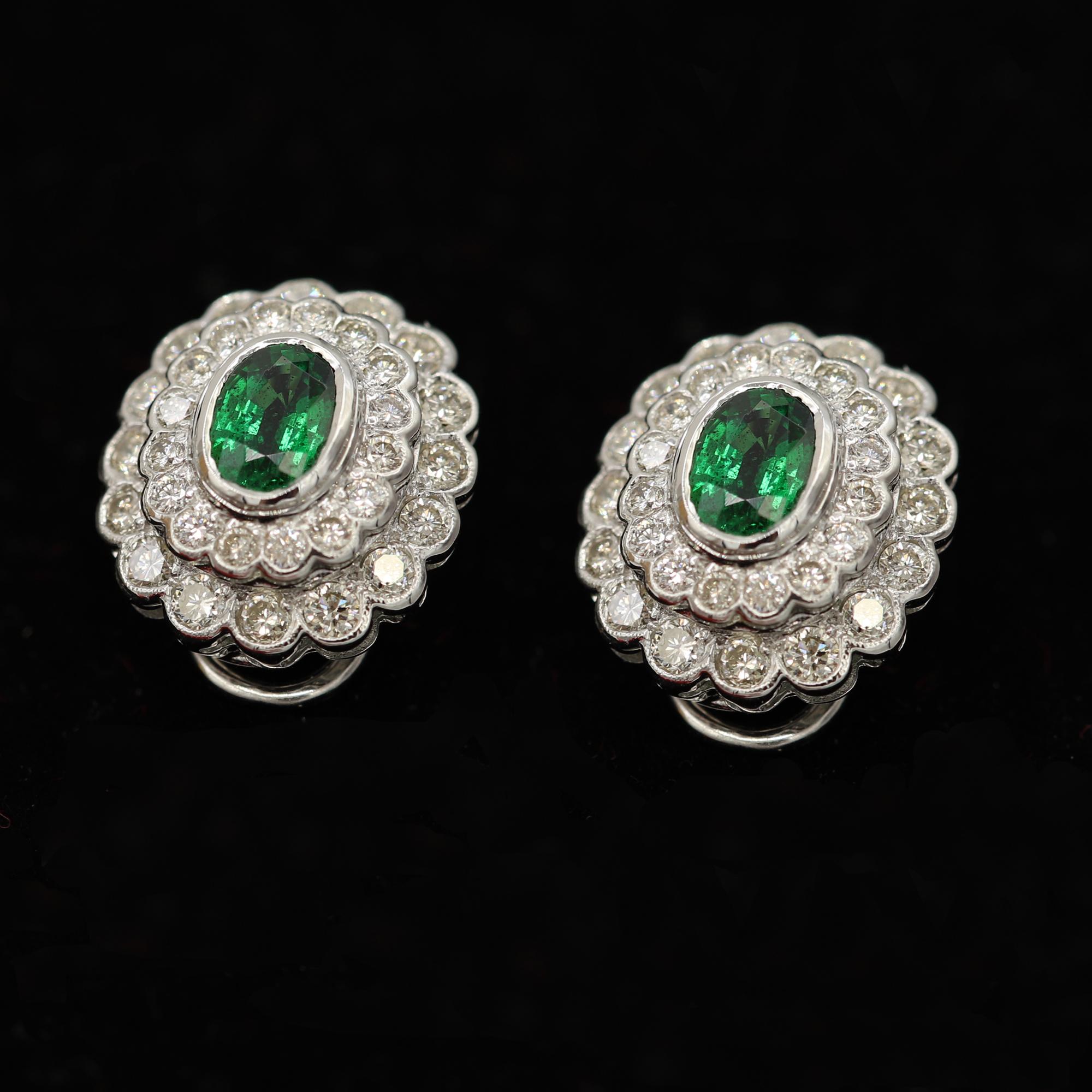 Brilliant Diamond and Tsavorite Earrings, Oval Shape Tsavorite size 7 x 5mm, 2.10 carat.
overall earring size 16 x 14 mm (about 3/4' x 1/2' inches). Brilliant Round Diamonds Total 1.83 carat GH-SI.
back type is omega post. please note: the post is