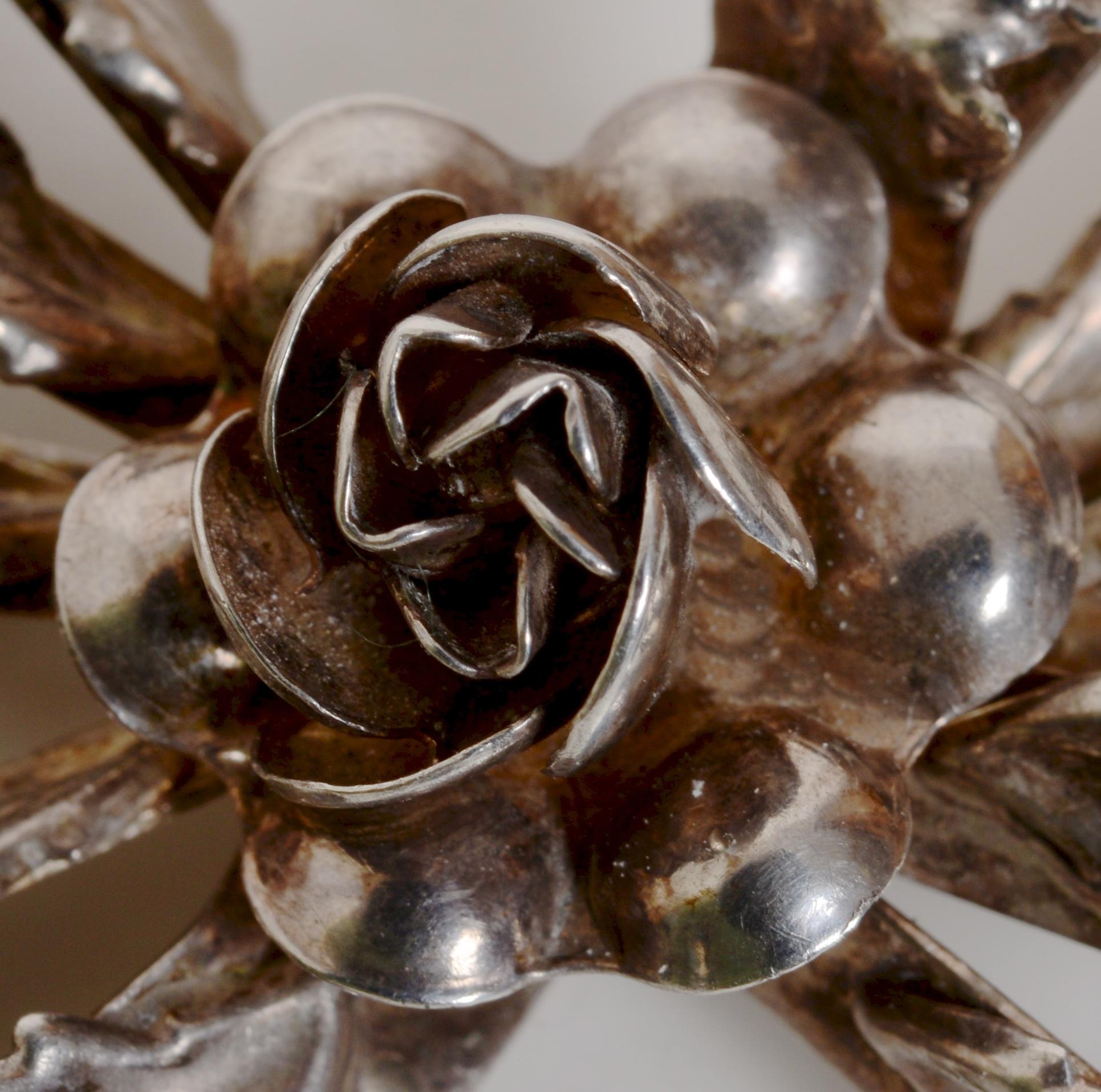 Classic Sterling Silver Brooch Ribbon and Flower Design, c1942, Signed Hobé. This is a classic collector's Hobé Sterling Silver floral and ribbon brooch with a rose in the center and buds set on a double ribbon bow. The brooch was designed in 1942