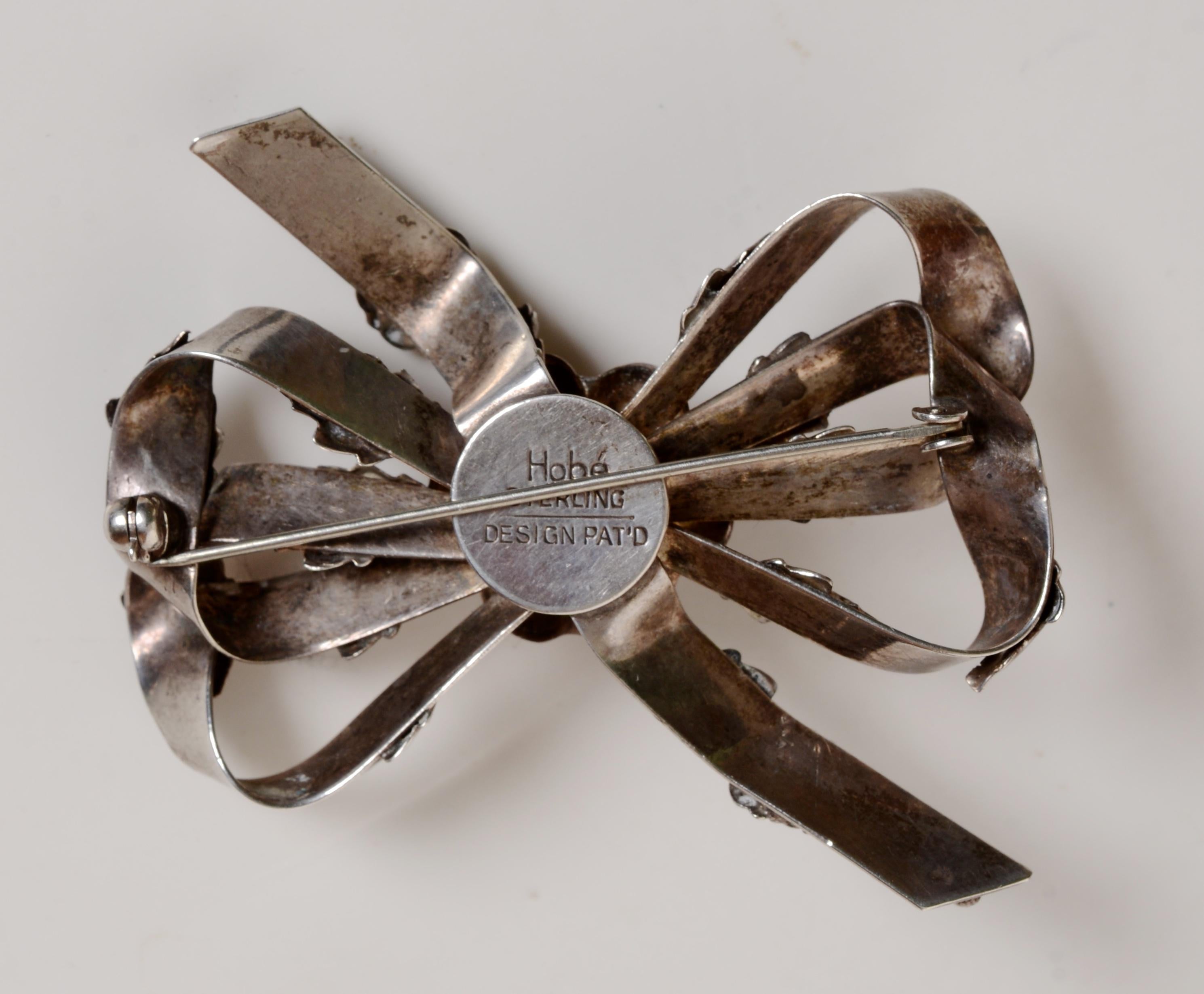 Retro   Classic Sterling Silver Brooch Ribbon and Flower Design, c1942, Signed Hobé For Sale