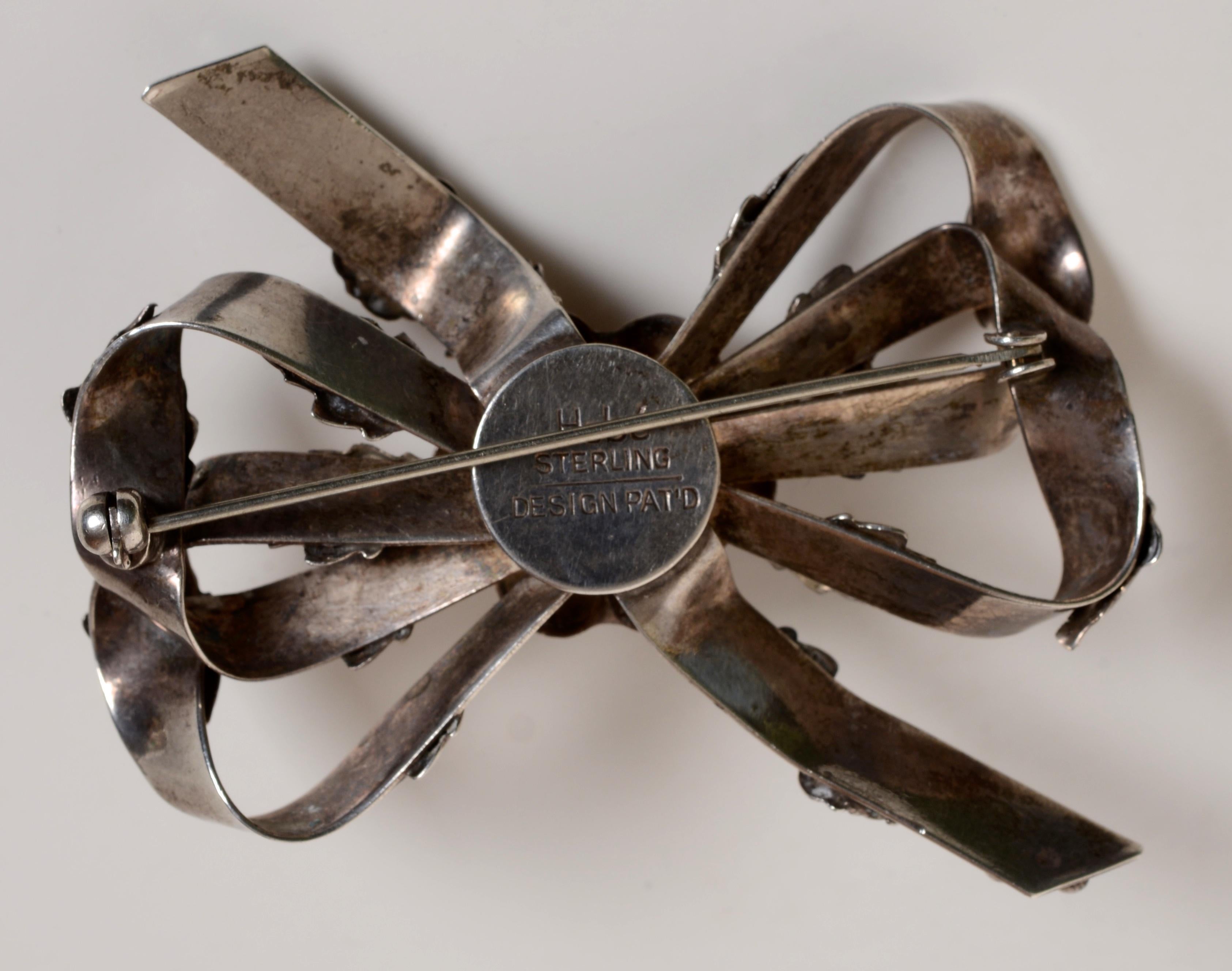 Women's Classic Sterling Silver Brooch Ribbon and Flower Design, c1942, Signed Hobé For Sale