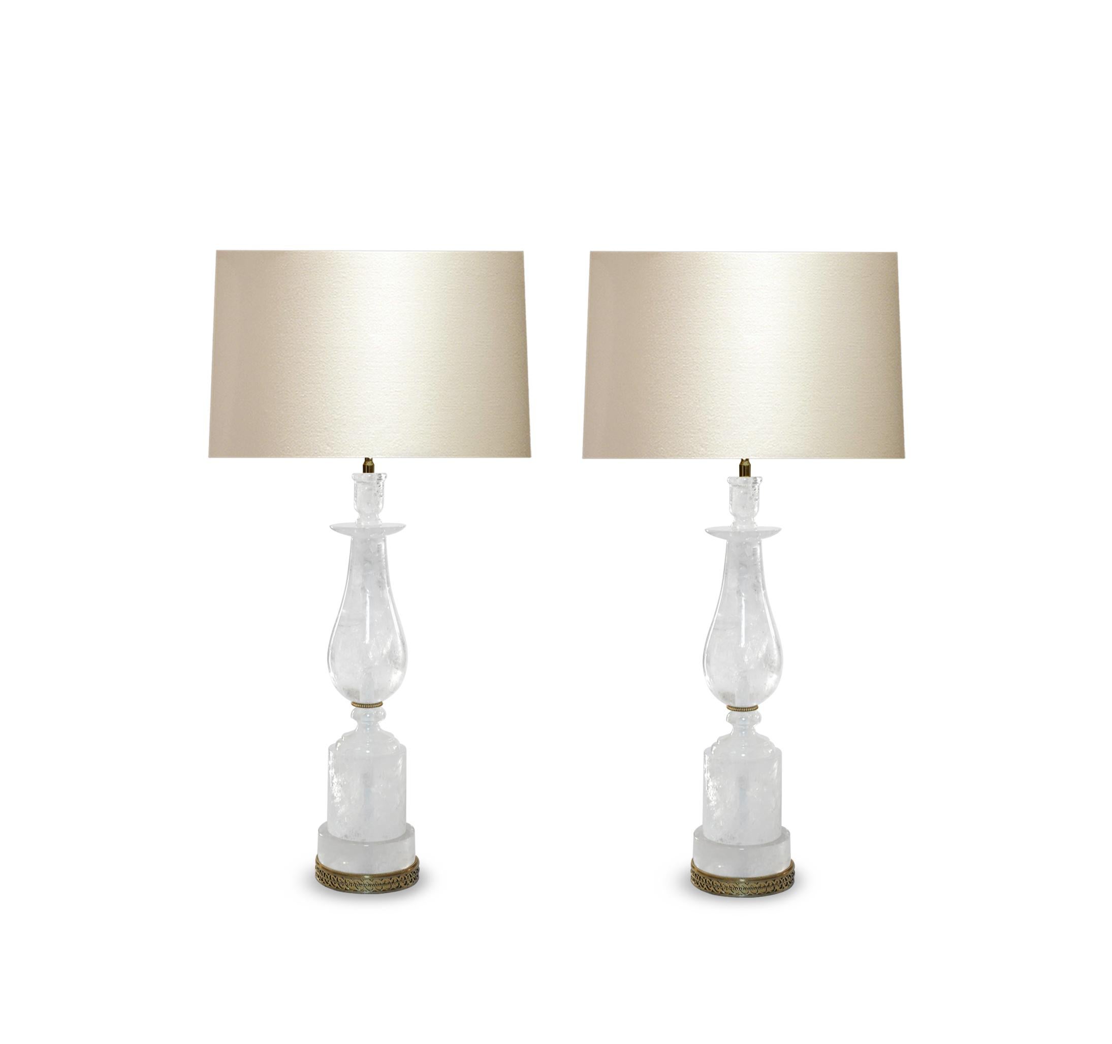 Pair of classic style rock crystal lamps with brass bases and decoration. Created by Phoenix Gallery, NYC.
Measures: To the rock crystal 22in/ H.
(Lampshade not included).