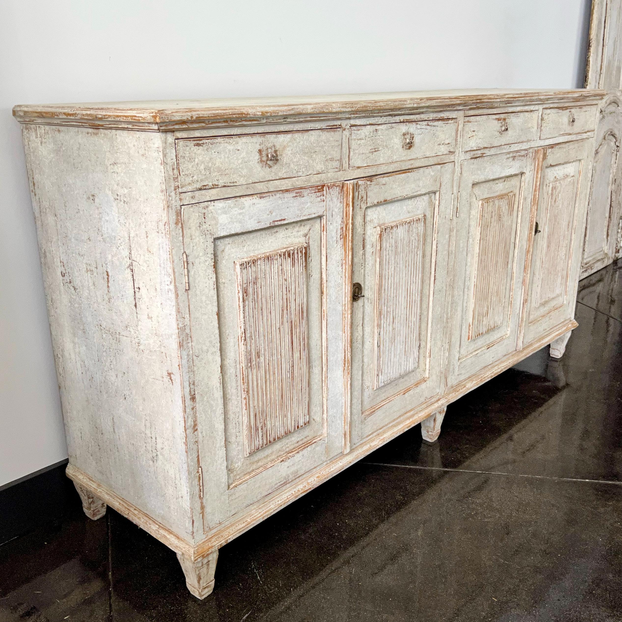 A rare four door Swedish sideboard in the classic Gustavian Style with carved reeded panel doors and bank of four drawers.
Sweden, circa 1800.