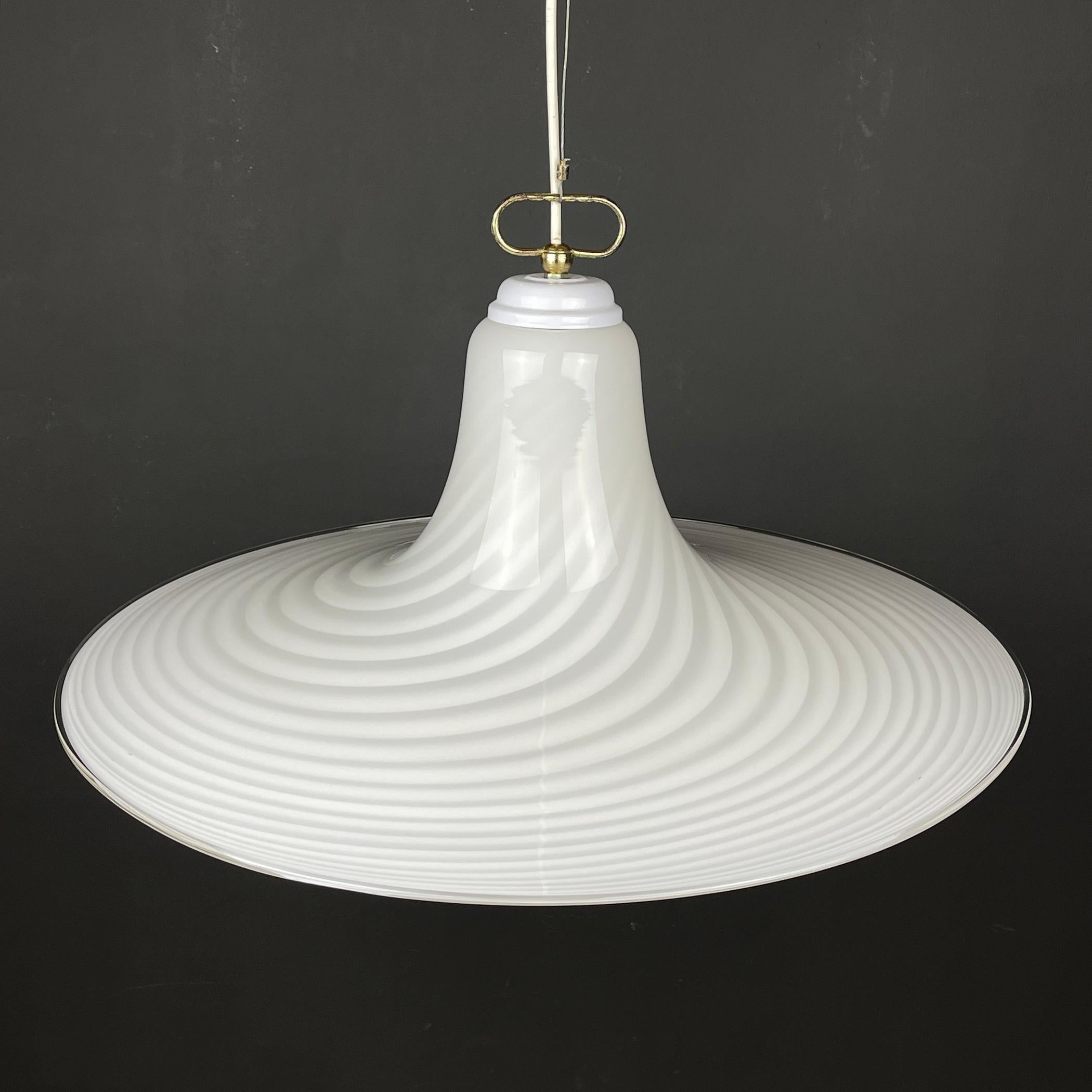 This swirl retro Murano pendant lamp was made in Italy in the 70s. Very beautiful white Murano glass with bends in the form of a tulip. Really good vintage condition. No chips or cracks. Requires a standard Edison E27 with a screw lamp. Chandelier
