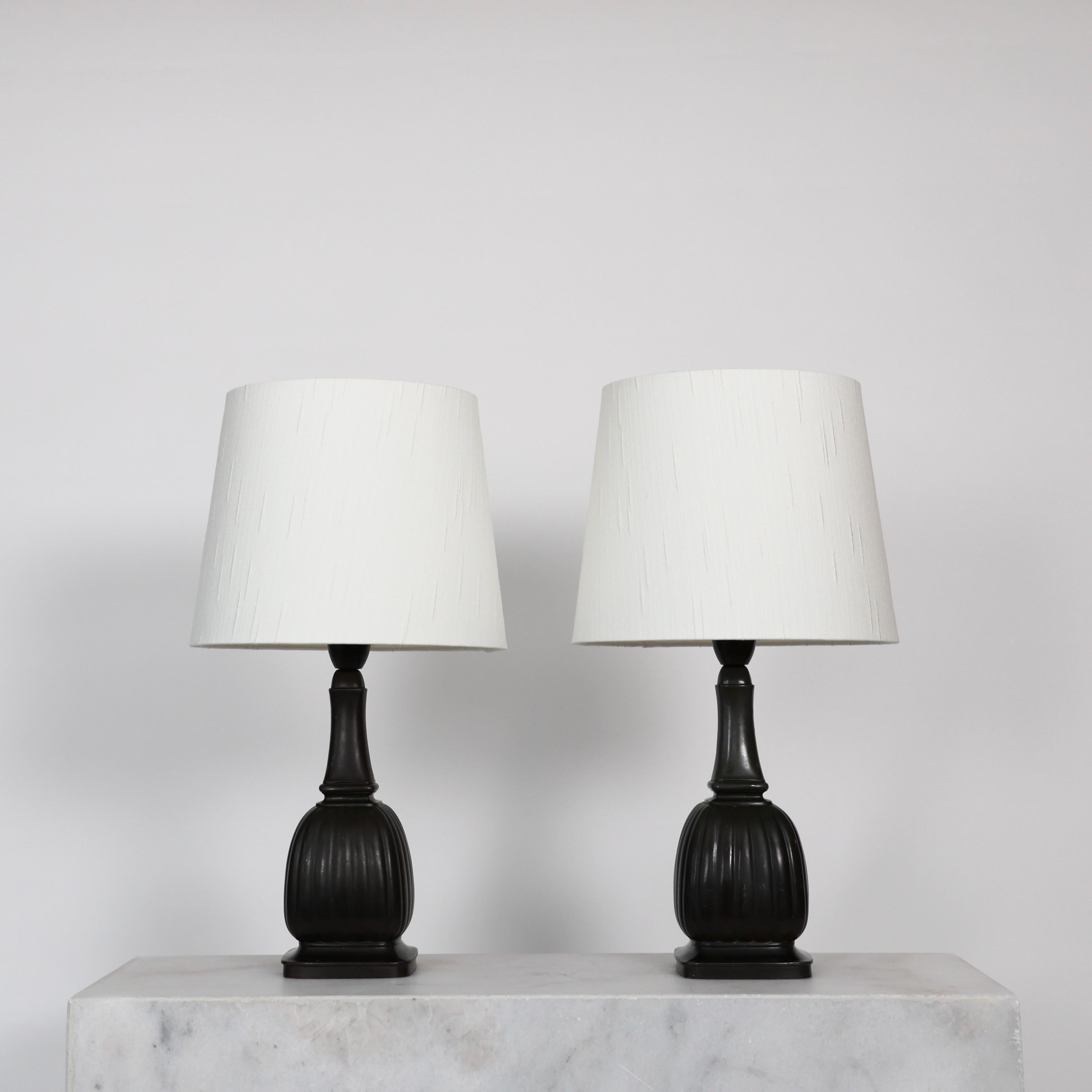 Set of timeless no. 1856 Diskometal Table Lamps made Just Andersen in the 1930s. 

* Set (2) of diskometal table lamps with square cannellated body and slim neck and white shade.
* Designer: Just Andersen
* Model: 1856
* Year: 1936
* Condition: Good