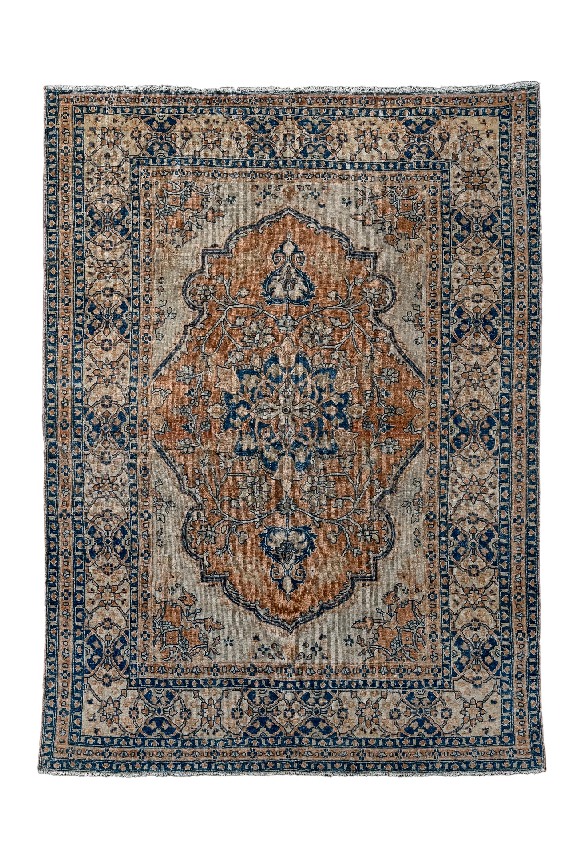 This is a classic “Hajji Jalili” Tabriz scatter, with a characteristic rust “Bookcover” field enclosing a pendanted dark blue medallion with  radiating tulips.  Extended ecru corners with roses.  Interlocking strip style cartouche border. Well woven