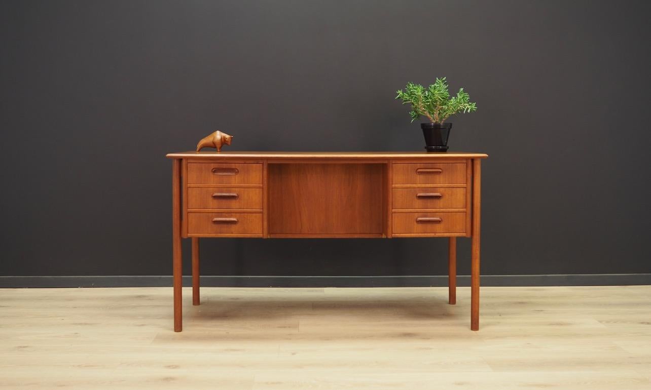 Excellent desk from the 1960s-1970s, minimalistic Danish design. Desk veneered with teak. Item has three drawers on each side. At the back a spacious drawer with a key and two bookshelves. Preserved in good condition (minor bruises, stain on one of