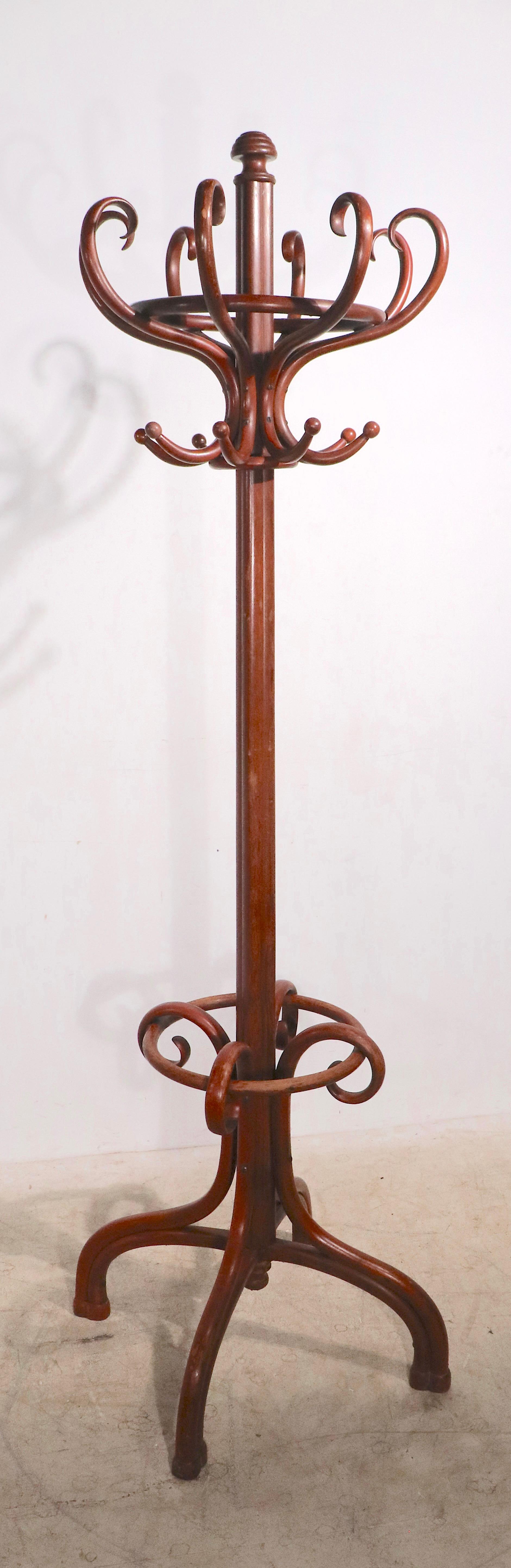 Classic bentwood coat tree rack by Thonet having 8 S shaped hooks and a circular umbrella, cane ring. This fine example is in very good, original, clean and ready to use condition, with original Thonet label intact on verso. Please view the