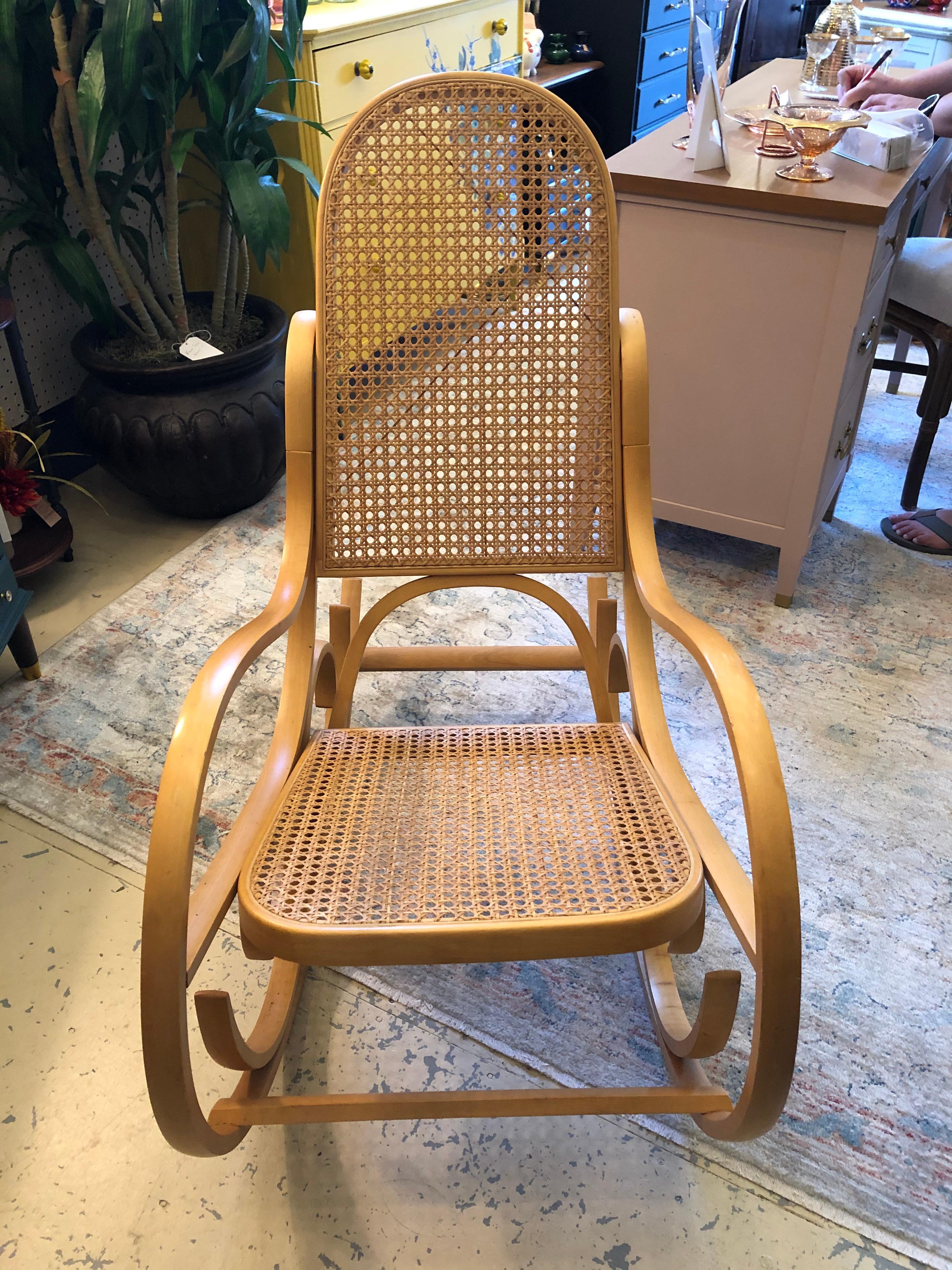 Classic Thonet style light colored bentwood rocking chair having the recognizable curlicues and caned wicker seat and back. Functions comfortably.

Diana B.