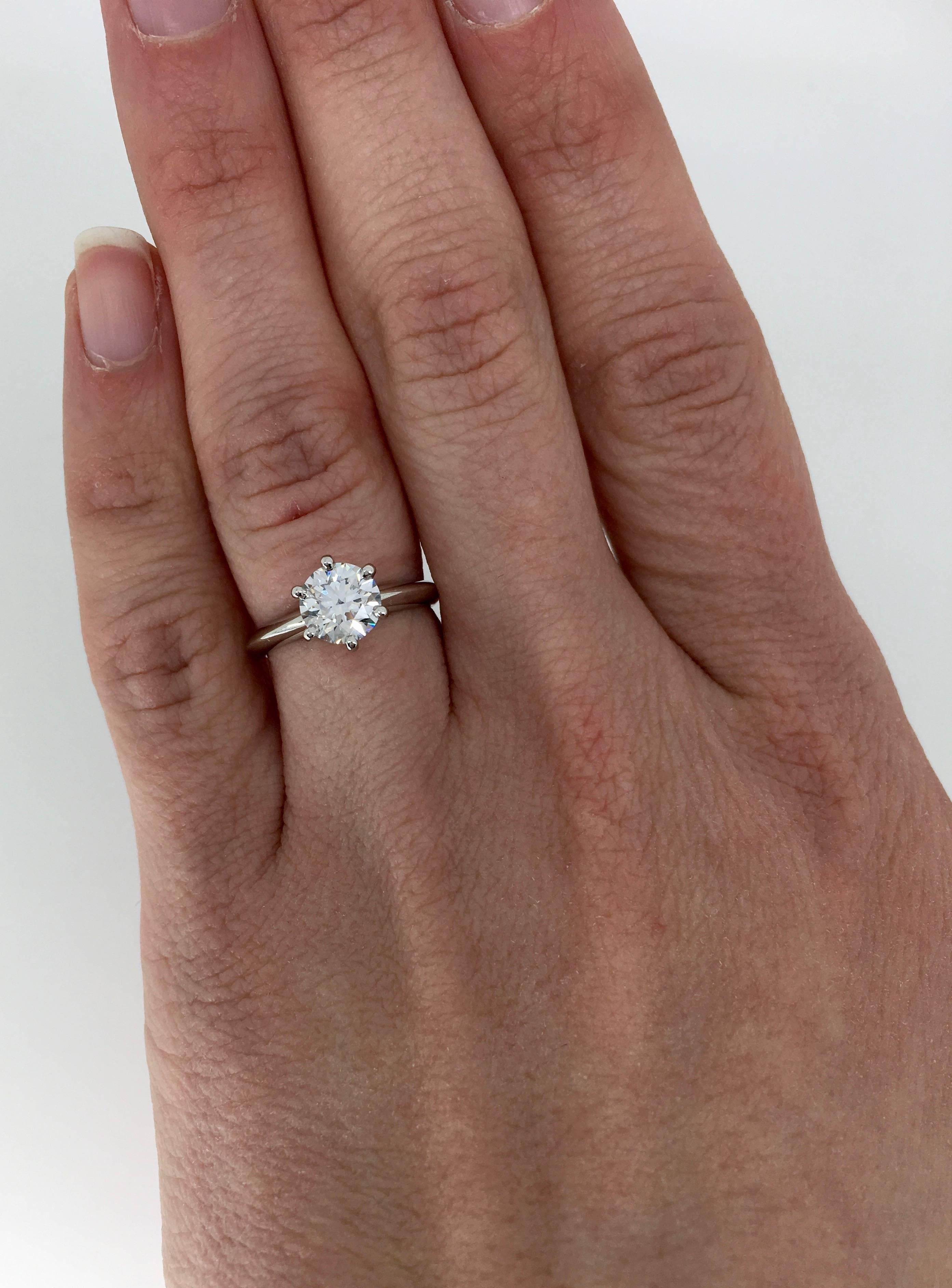 This authentic Tiffany & Co. classic 6 prong solitaire features a GIA Certified 1.08CT Round Brilliant Cut Diamond with E color and VVS2 clarity. The platinum ring is currently a size 4 and weighs 4.4 grams. The ring is stamped with the makers mark