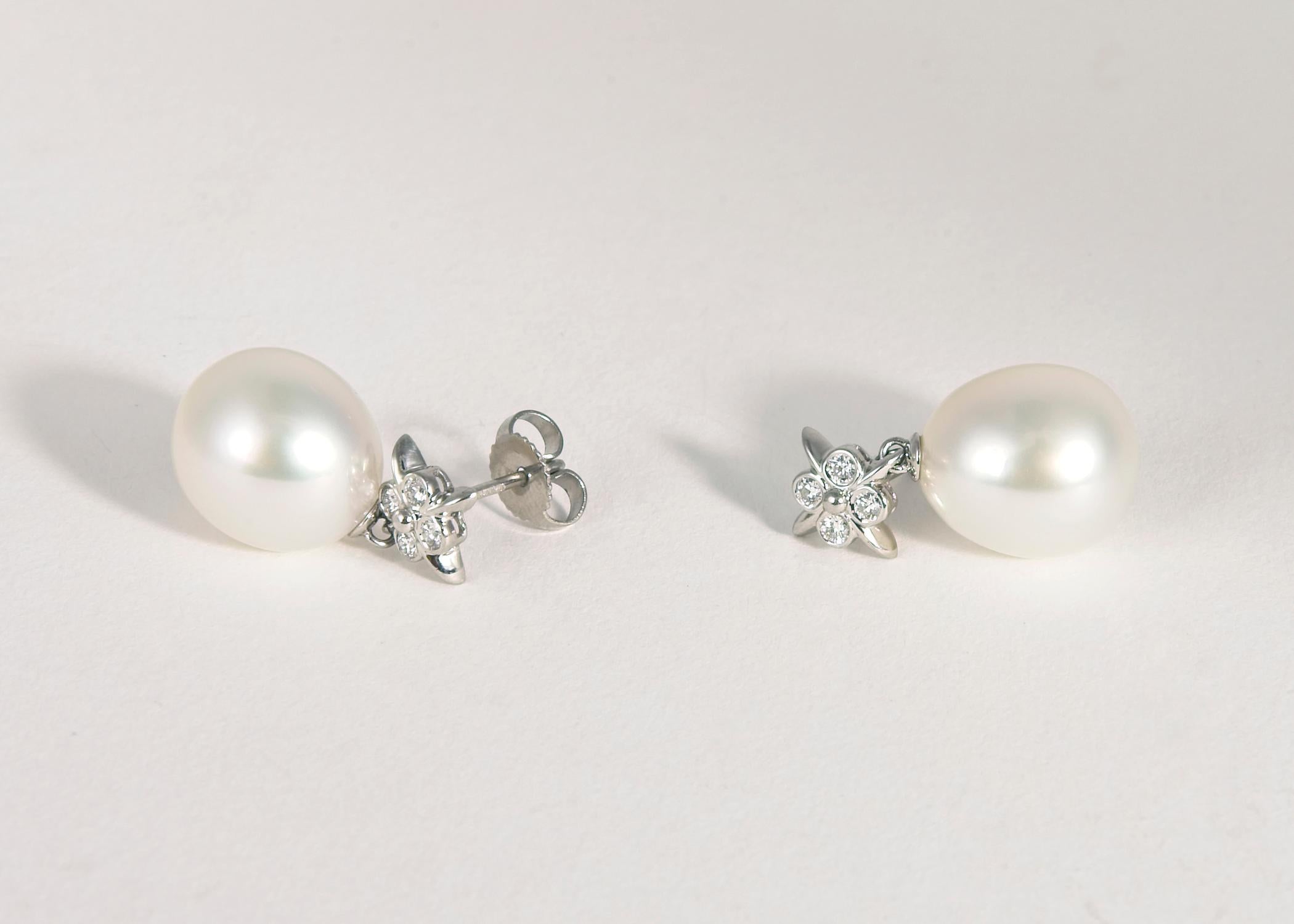 A Tiffany Classic. A matched pair of South Sea pearls ( 13.3 x 11.9mm ) is combined with the purity of platinum and finished with eight brilliant cut diamonds. Approximately 1 inch in length. Simply elegant !!!