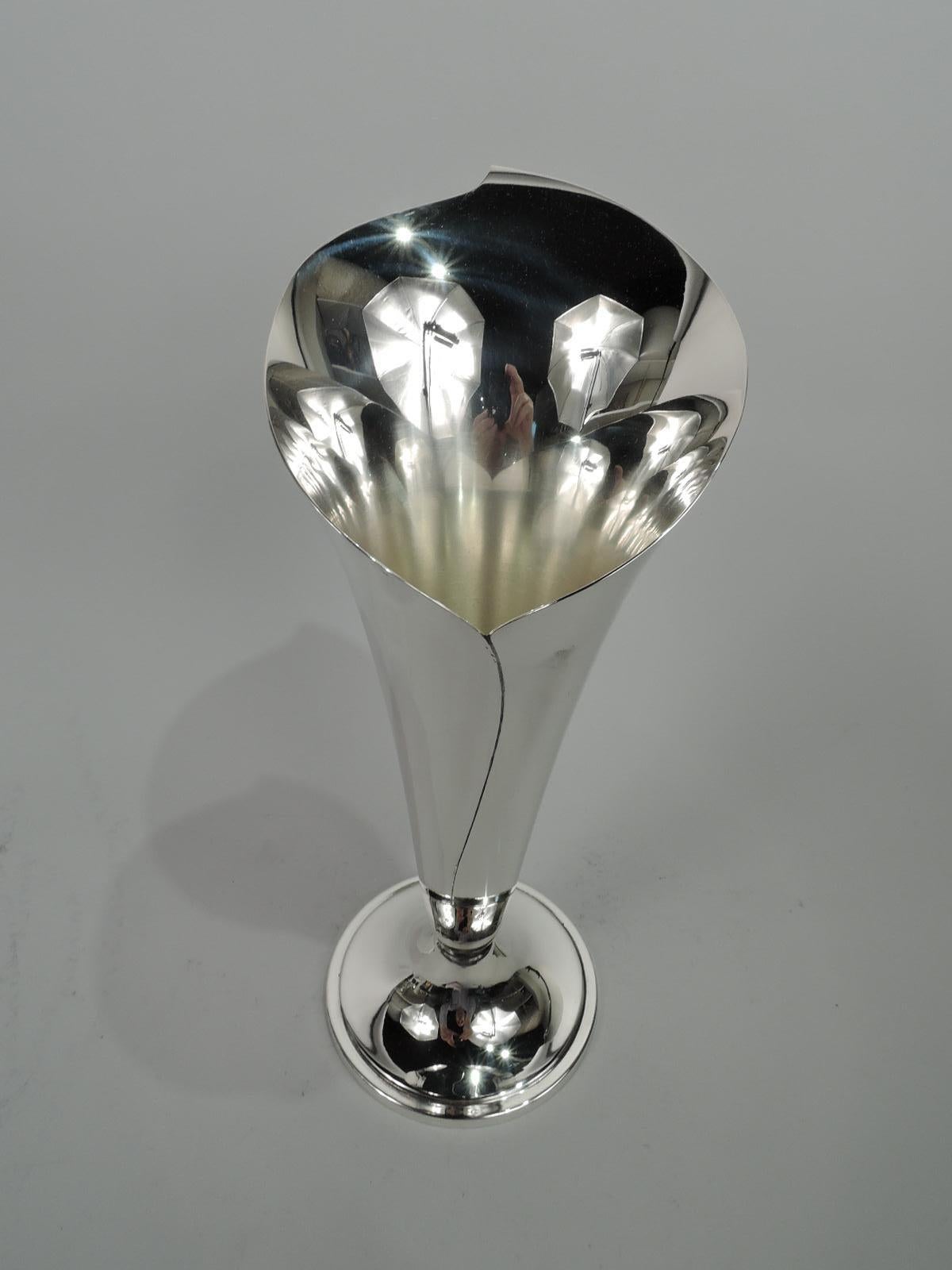 Classic Mid-Century Modern sterling silver vase. Made by Tiffany & Co. in New York. In form of abstract calla lily with asymmetrical mouth and irregular seam. Raised round foot. Marked: “© Tiffany & Co. Makers Sterling Silver 23425 925”. Weight: