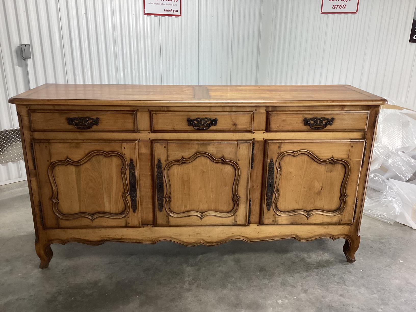 Solid cherry French sideboard having 3 paneled doors and 3 drawers above. The top is made of warm solid cherry wood planks . Drawers are dove tailed and wood dowels are visible. The iron hardware on the drawer pulls and doors is original and very