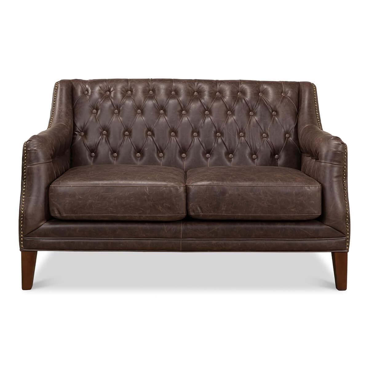 A Classic tufted two-seat sofa with a bicast bonded chocolate-colored vintage style leather upholstery, with a tufted cushion backrest, and sides with two cushions on square tapered legs and finished with brass nailhead trim details.

Dimensions: