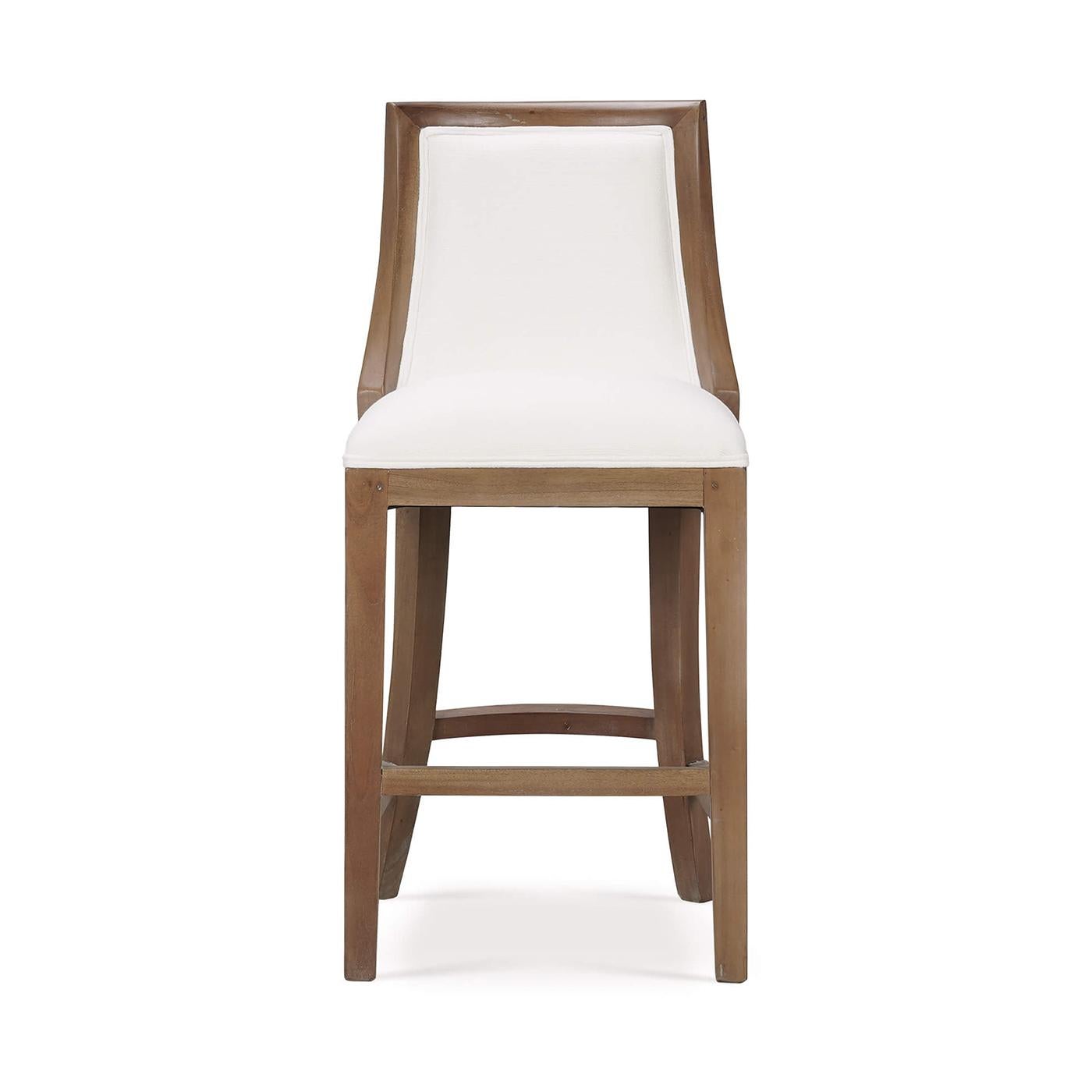 This counter stool features a sturdy wooden frame finished in a warm straw wash, providing both durability and a natural, elegant appeal. The seat and backrest are upholstered in Arctic White performance fabric, offering superior comfort and easy