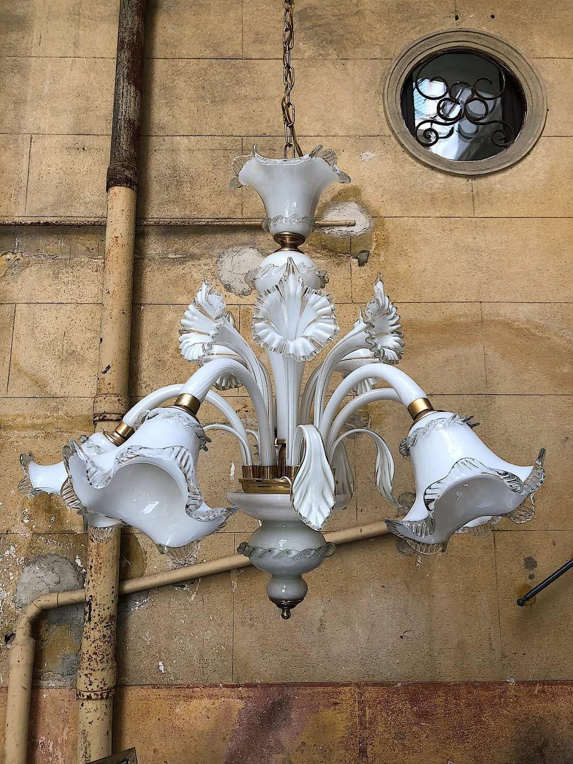 One of a kind vintage Murano chandelier, ca 1980s. The light has 5 bulbs.
Five leafs and 5 striped flowers. Note that we have two chandeliers available so you have the possibility to make a pair. 
Details
Creator: Murano

Dimensions: Height 75